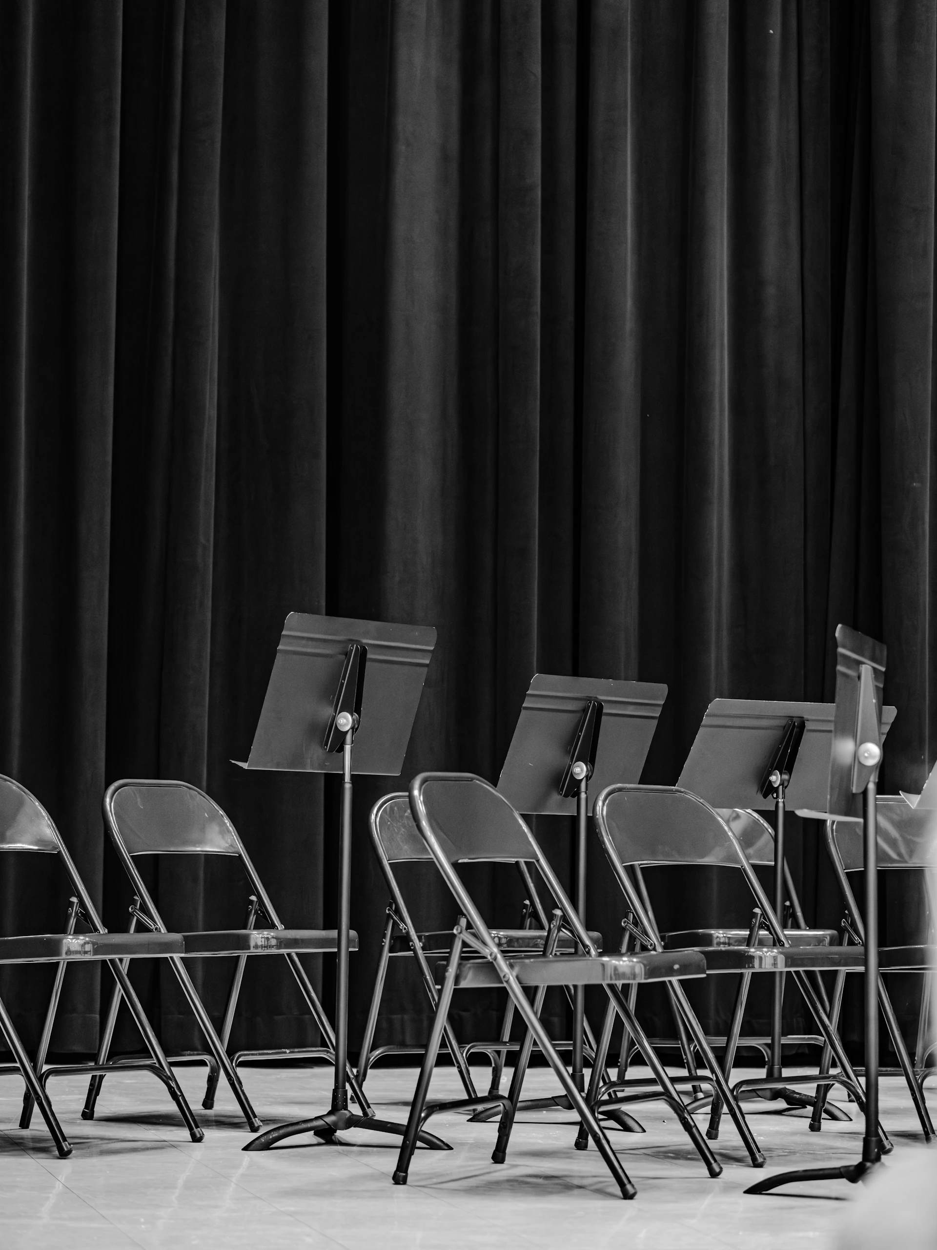 Empty chairs and music stands on stage