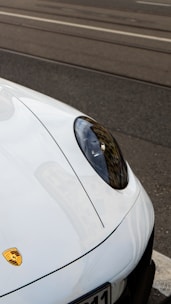 White porsche car hood with emblem and emblem