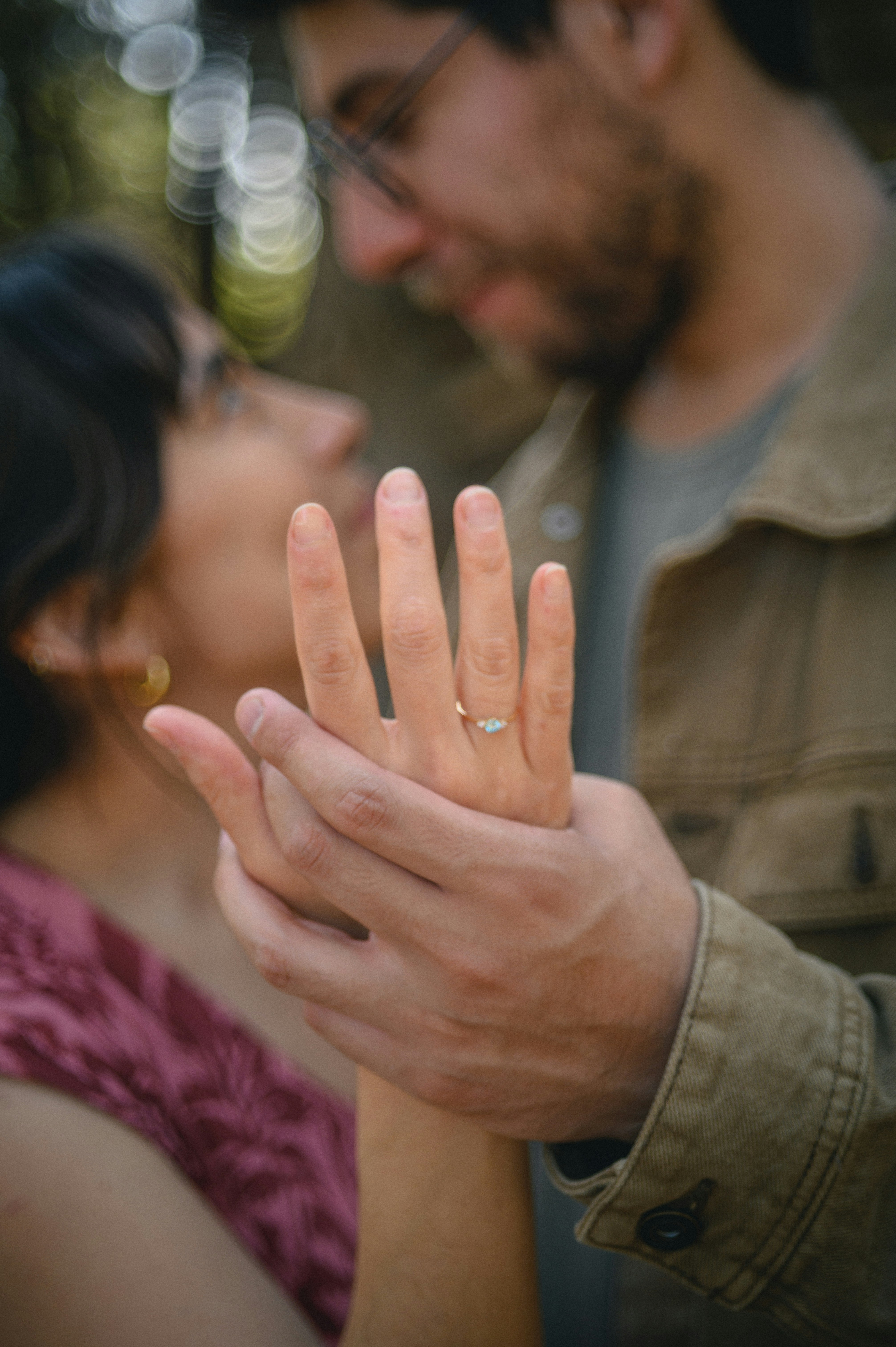Couple showing off engagement ring on hand