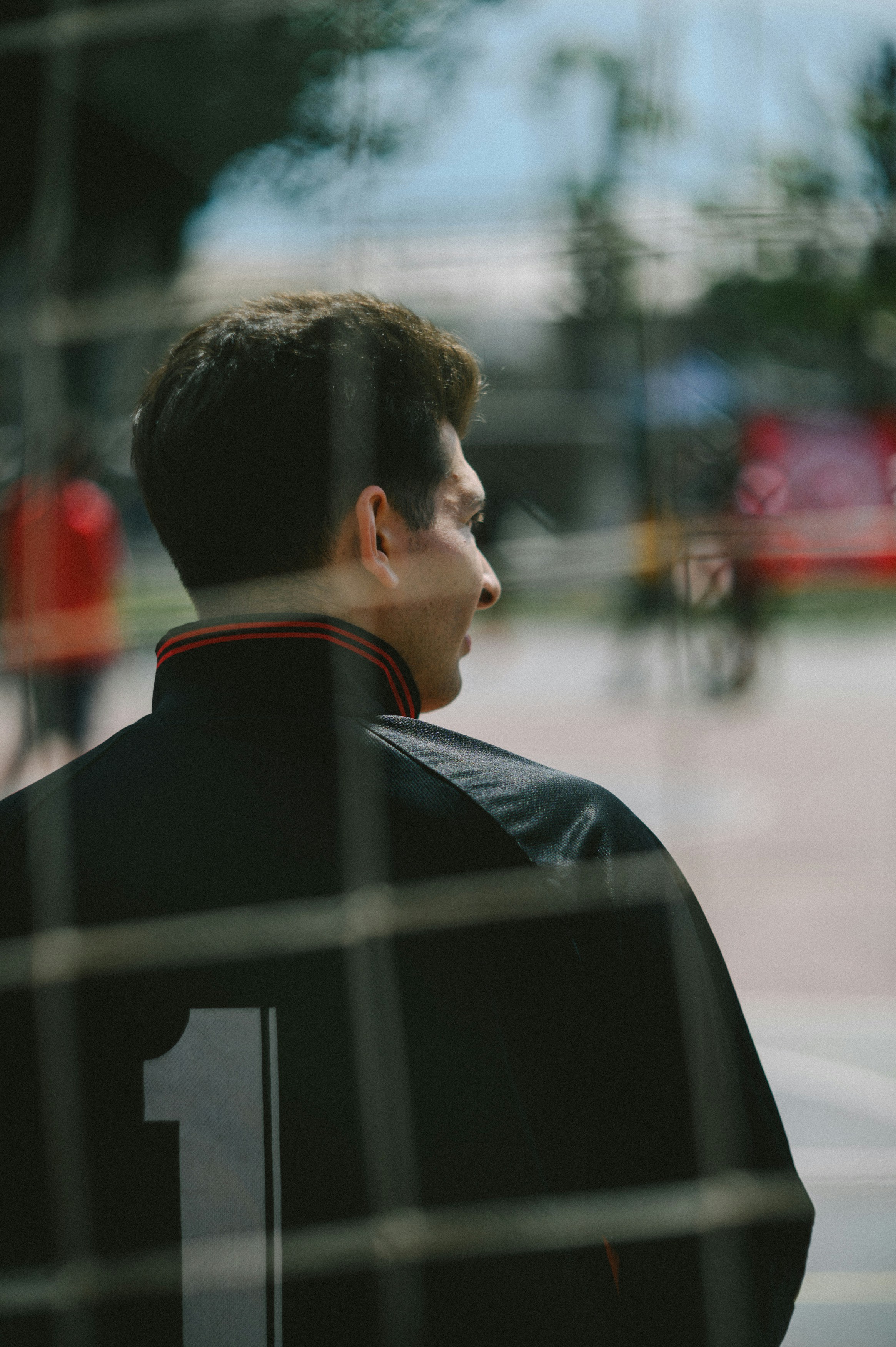 Man wearing a black jacket with number one