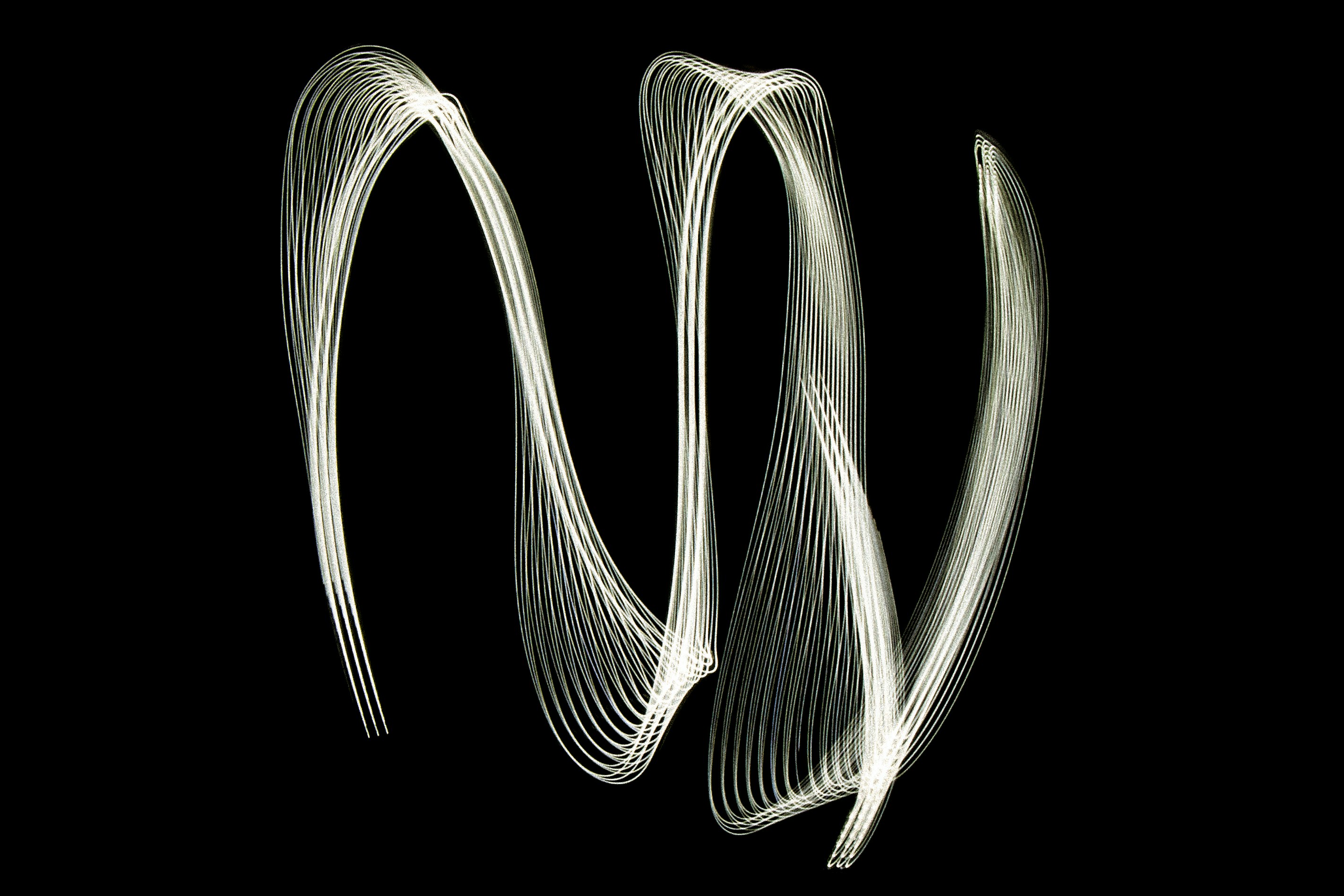 White light trails form a spiral on black background