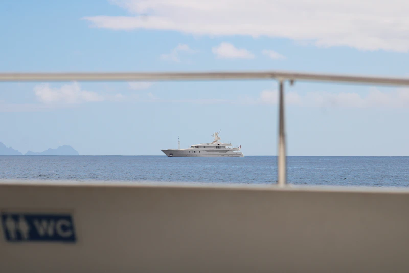 A large yacht sails on the blue ocean.