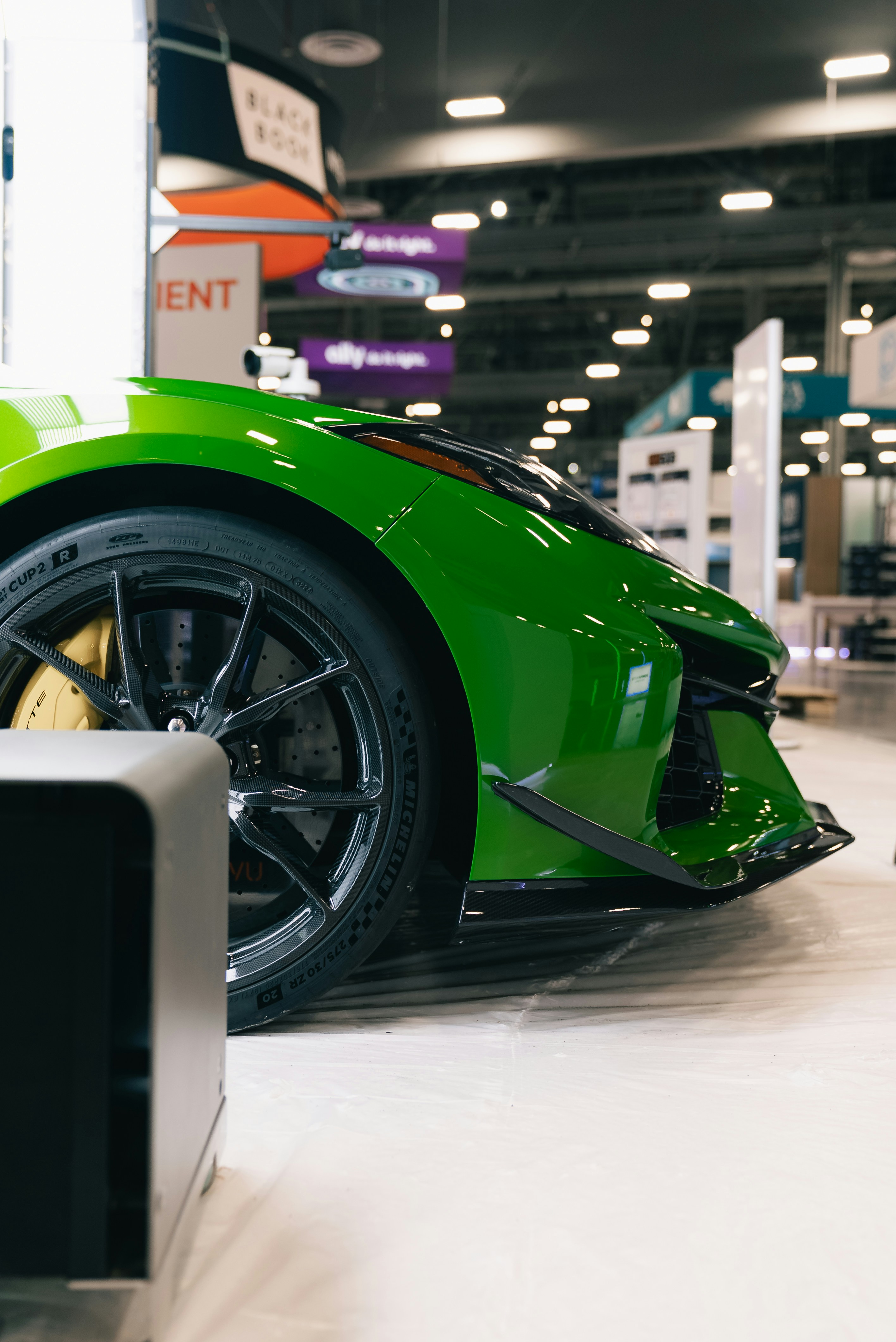 A bright green sports car on display indoors