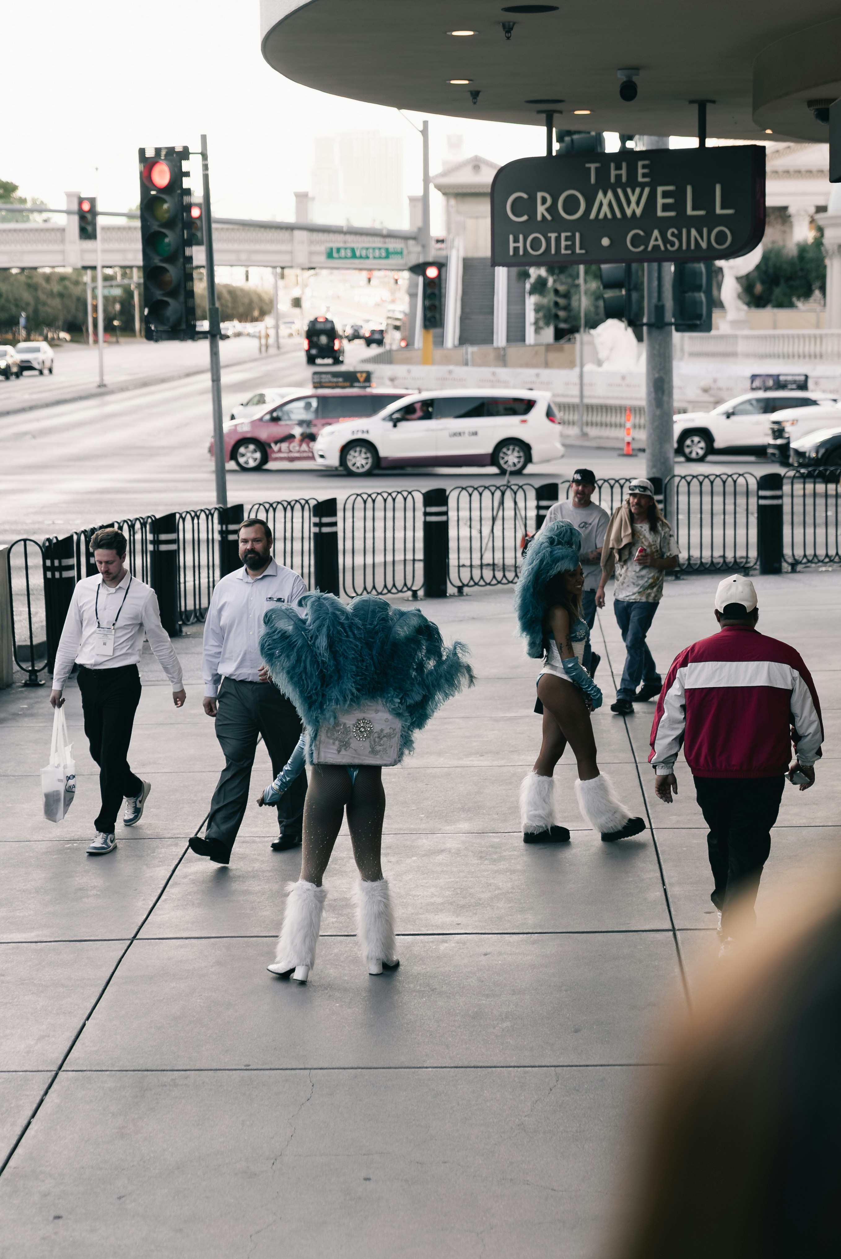 People walking on a sidewalk outside the cromwell hotel