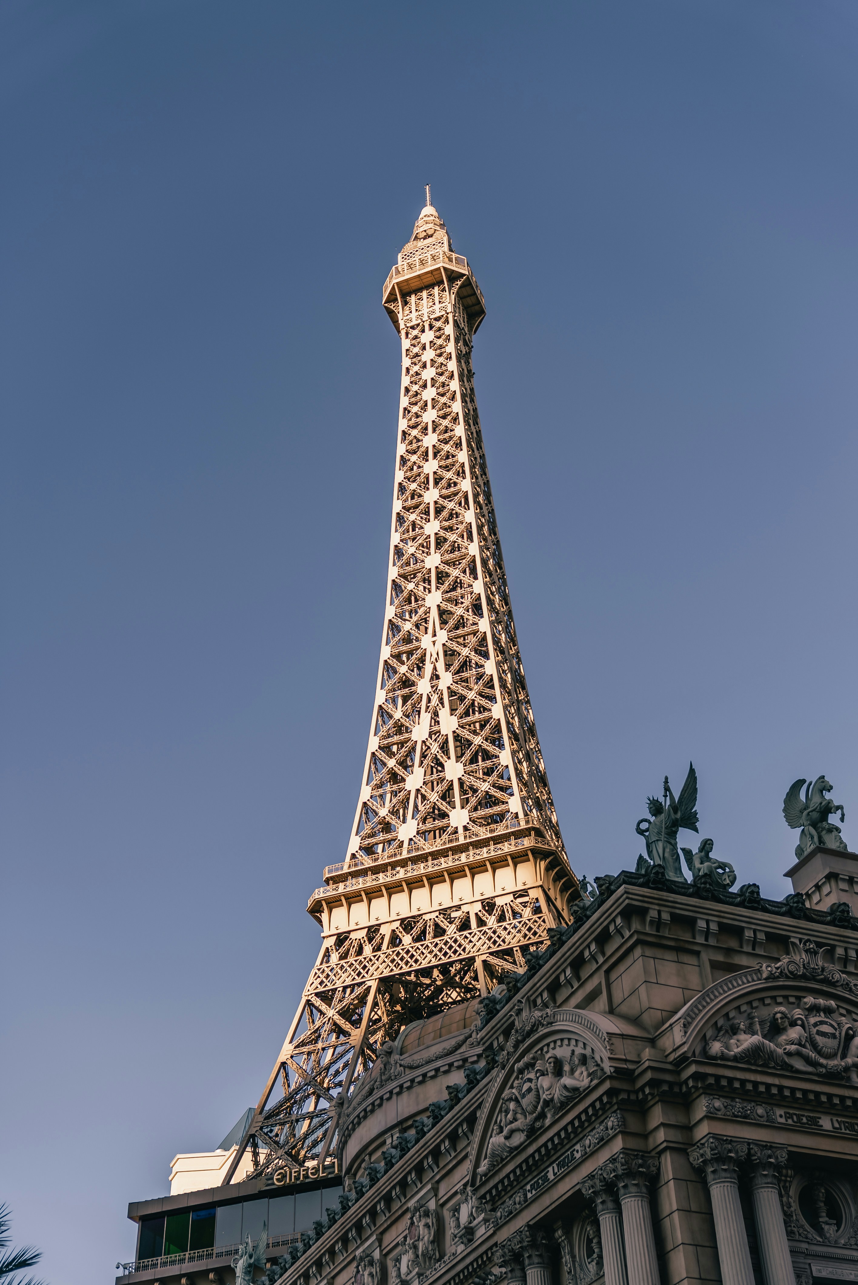 Eiffel tower replica against a clear blue sky.