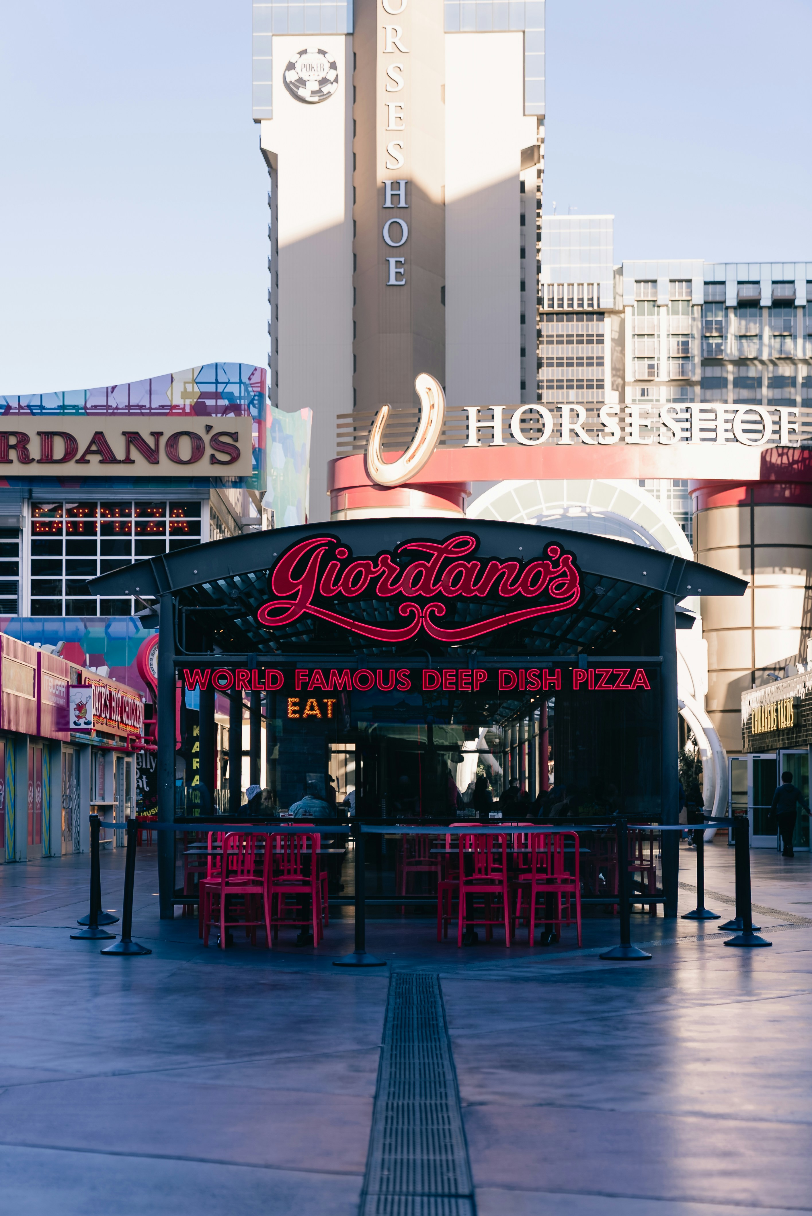 Giordano's restaurant with red chairs and tables outside