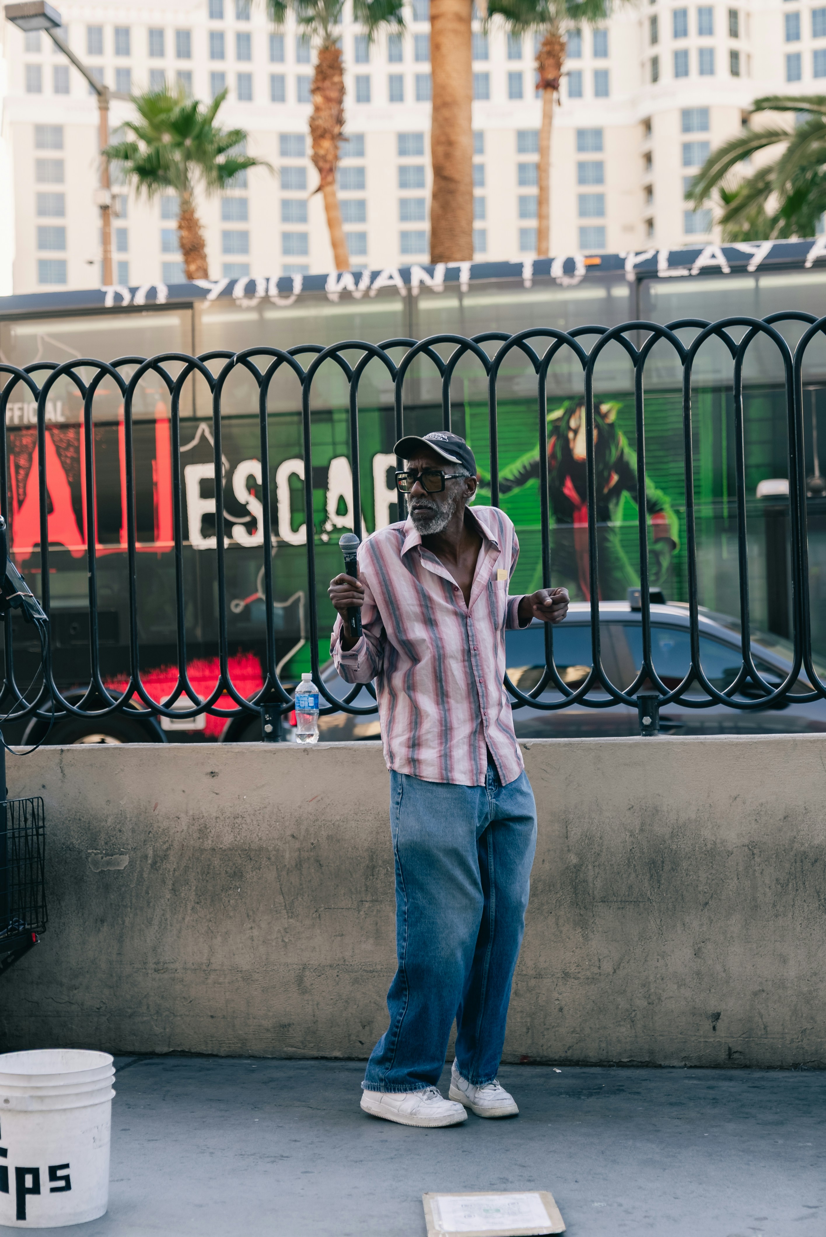 Elderly man dancing on street with building background