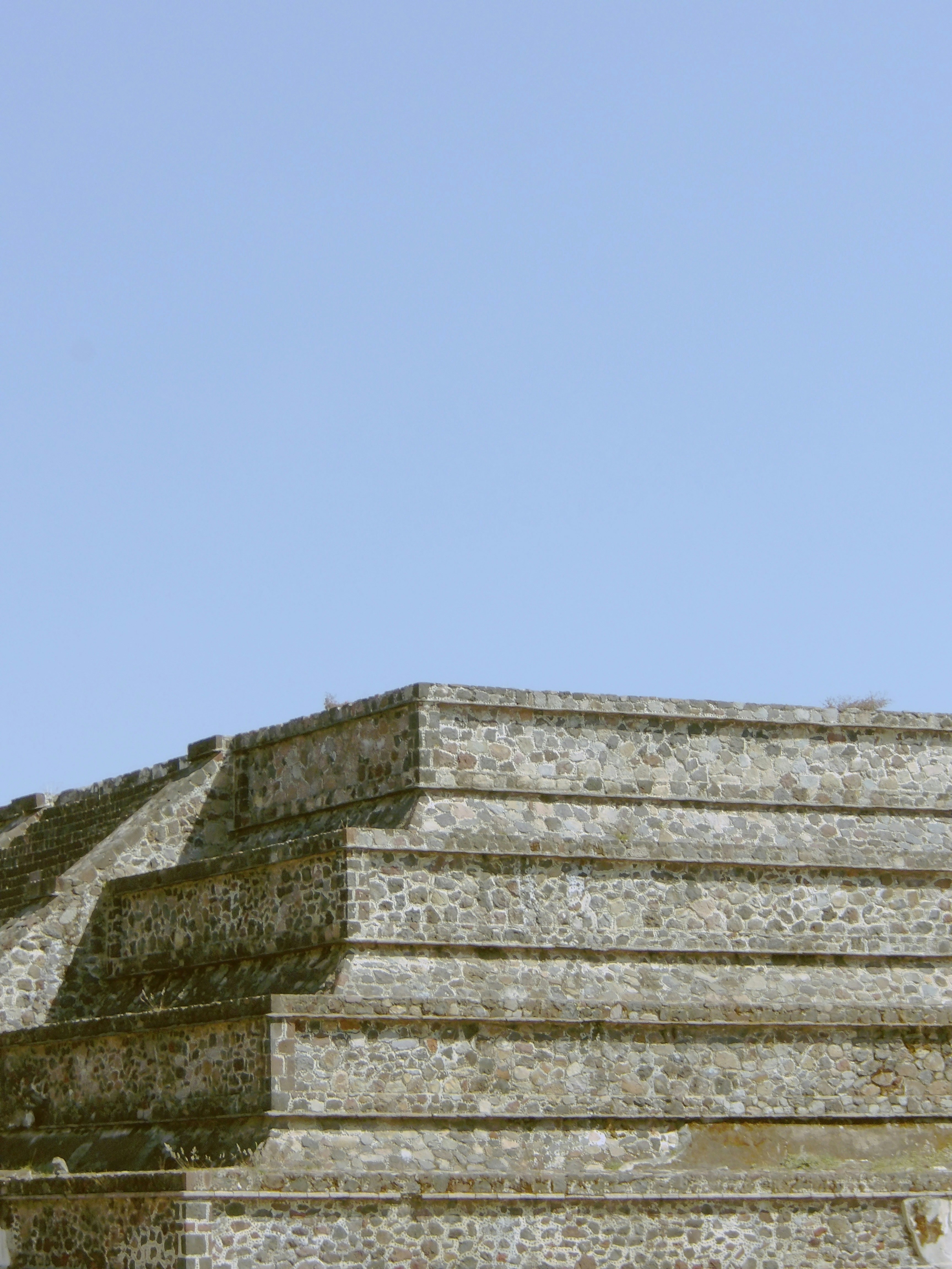 Stone pyramid steps against a clear blue sky