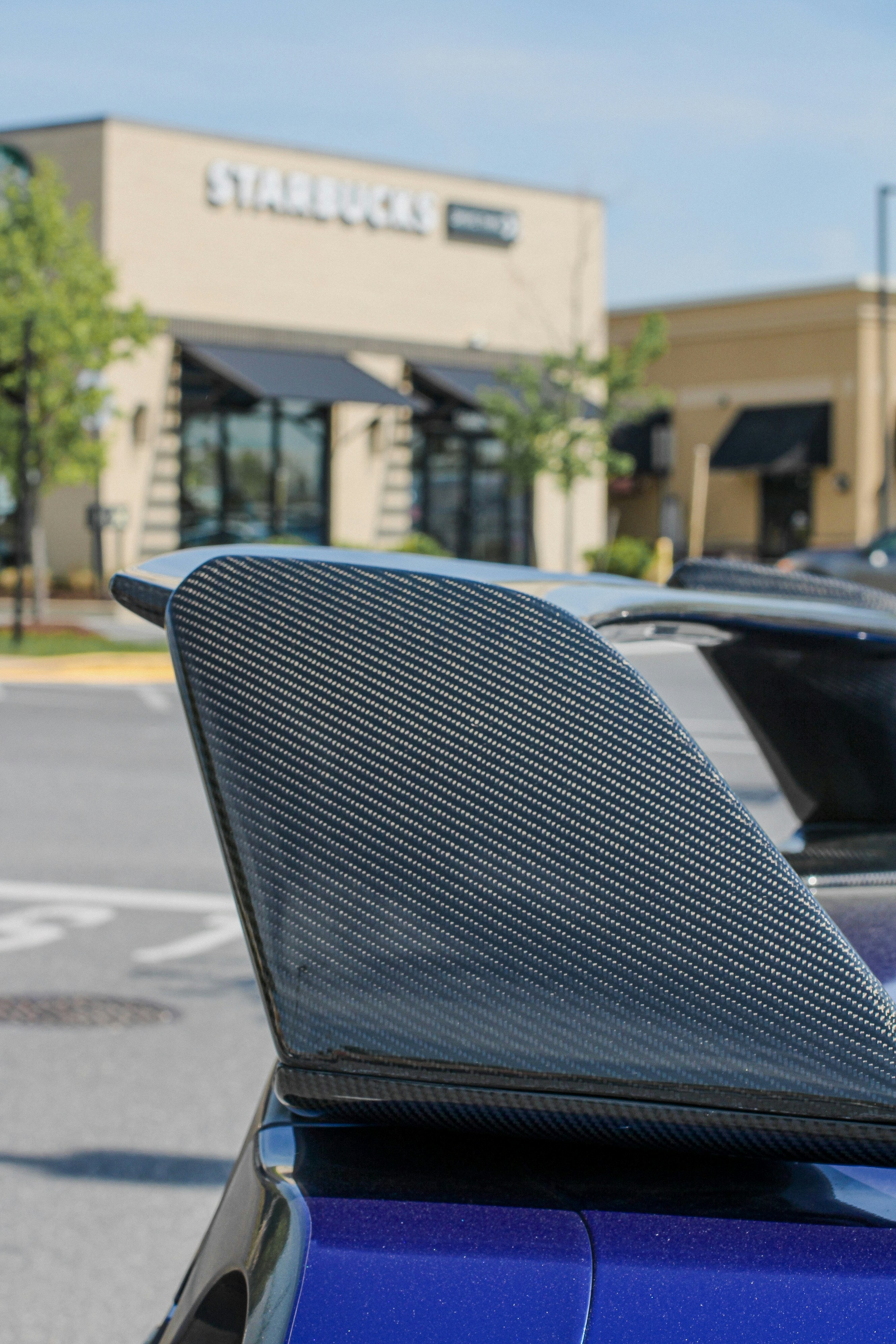 Close-up of a car's carbon fiber spoiler