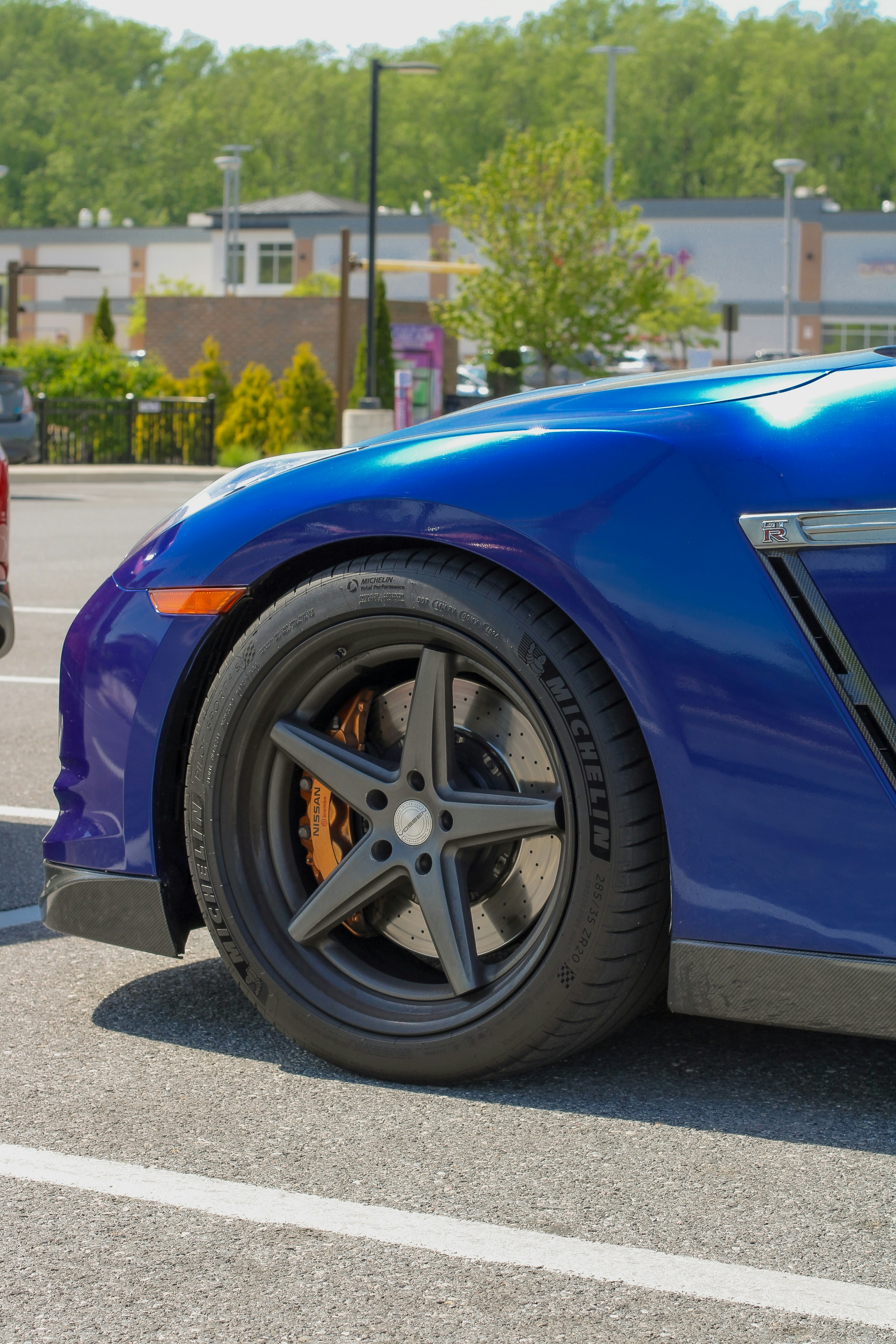 Blue sports car wheel and fender detail