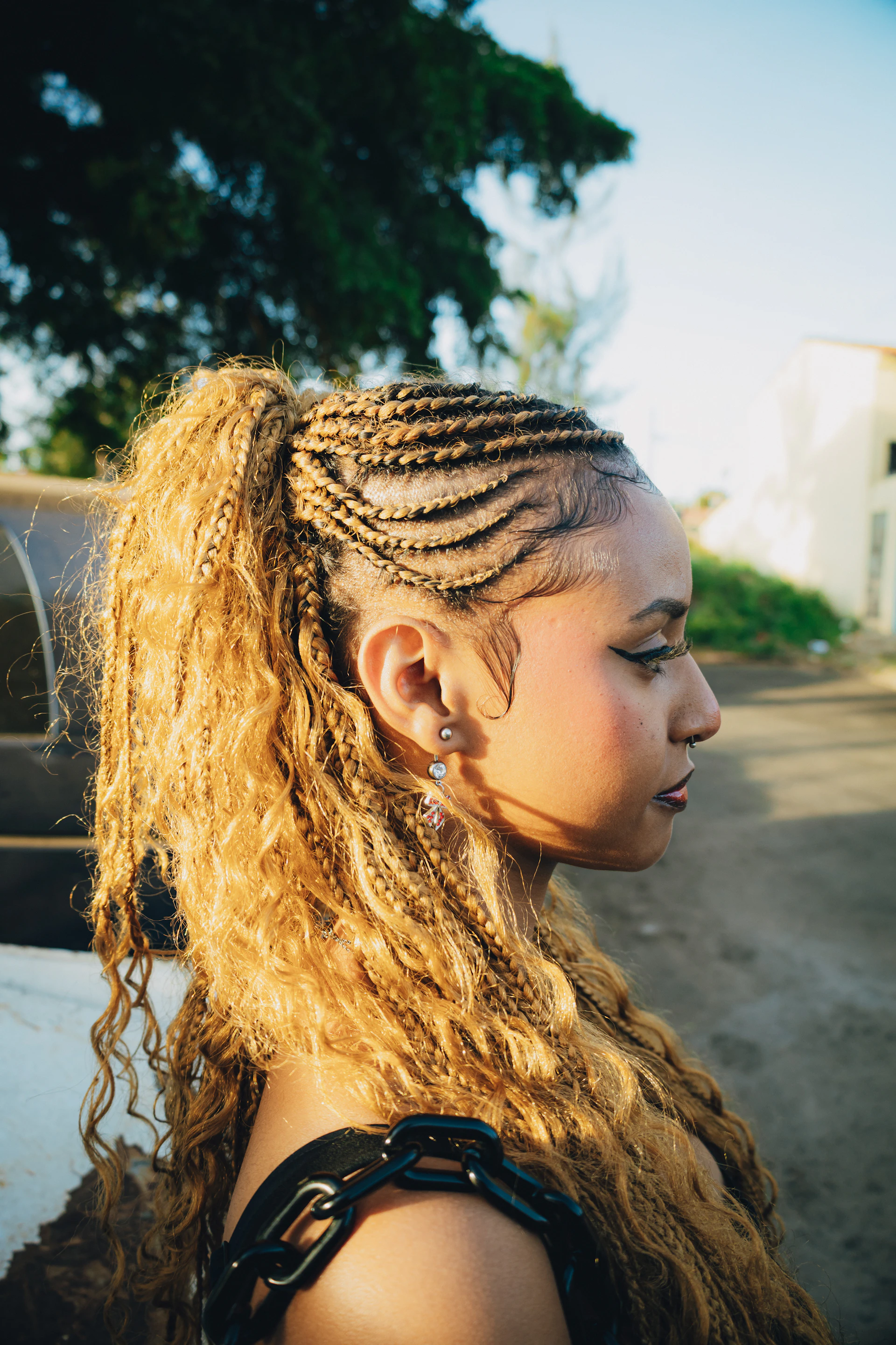 Woman with blonde braided hair and ponytail outdoors