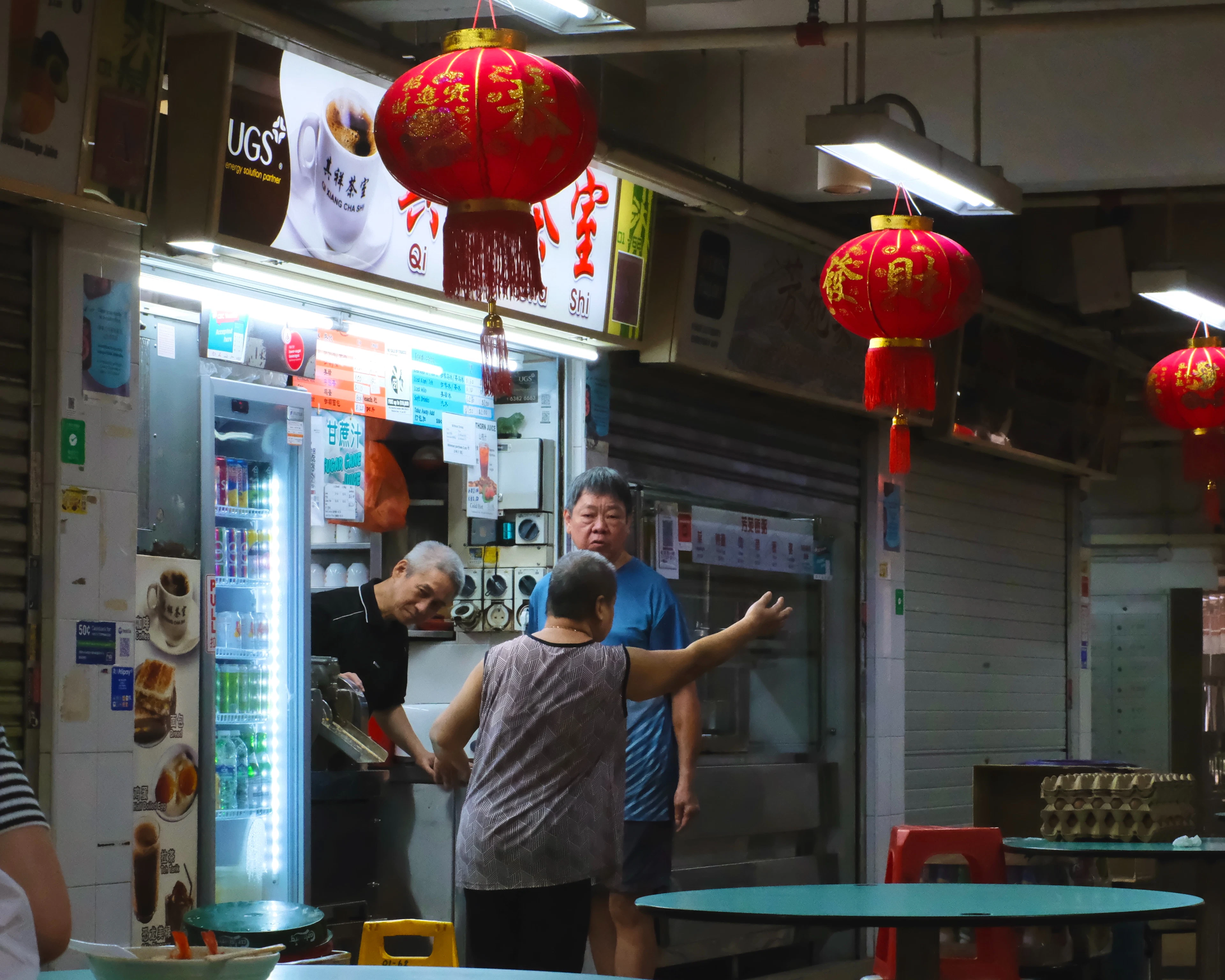An old-school drinks stall hung with red lanterns at Hong Lim Market & Food Centre, near Chinatown