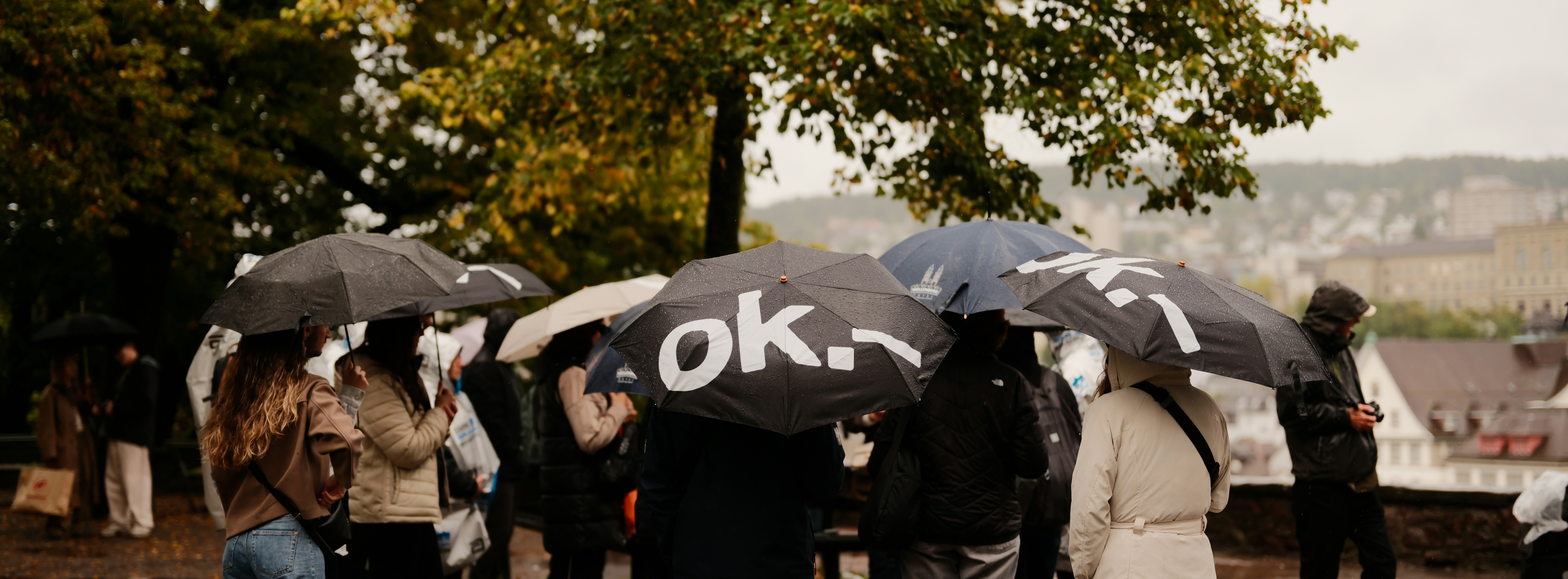 People holding umbrellas in the rain
