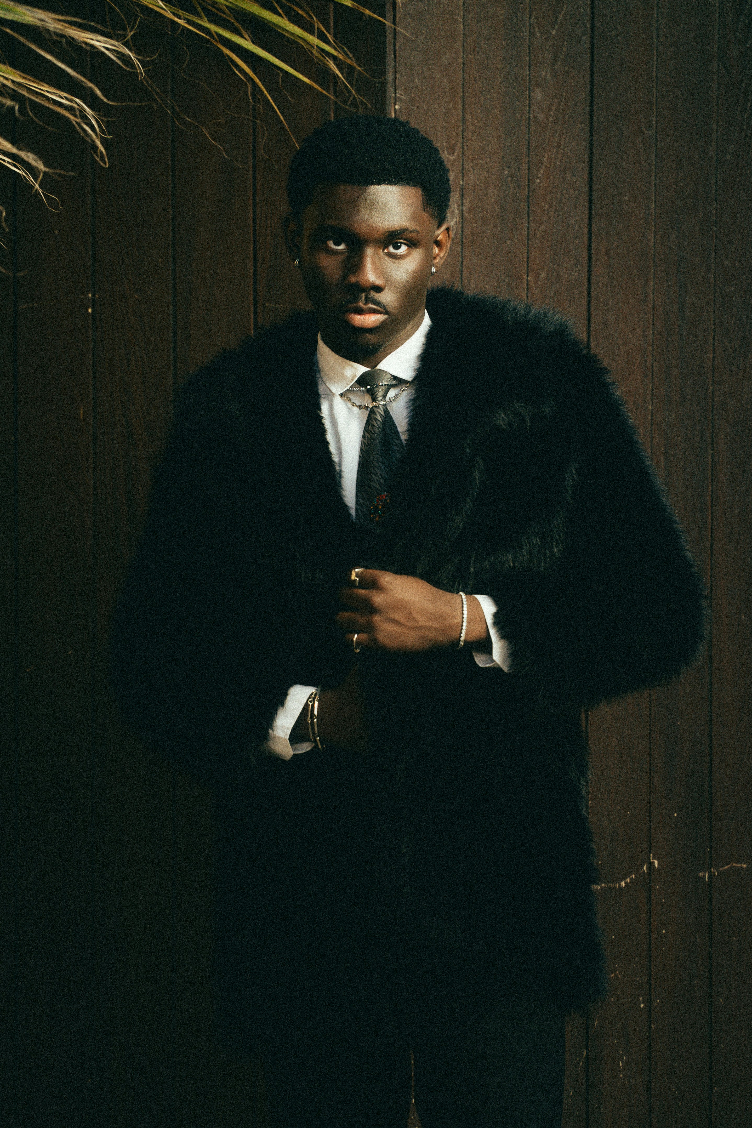Man in a black fur coat and suit