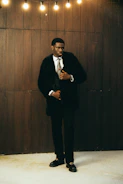 Man in a black fur coat and suit