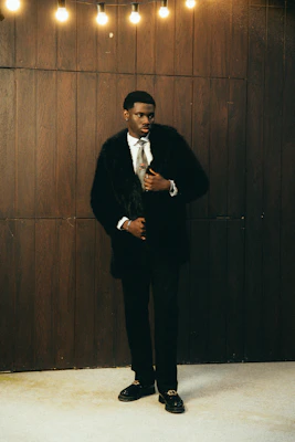 Man in a black fur coat and suit
