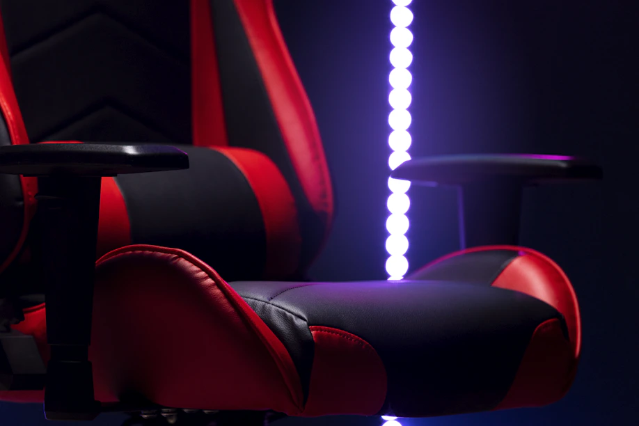 A red and black gaming chair with purple lights