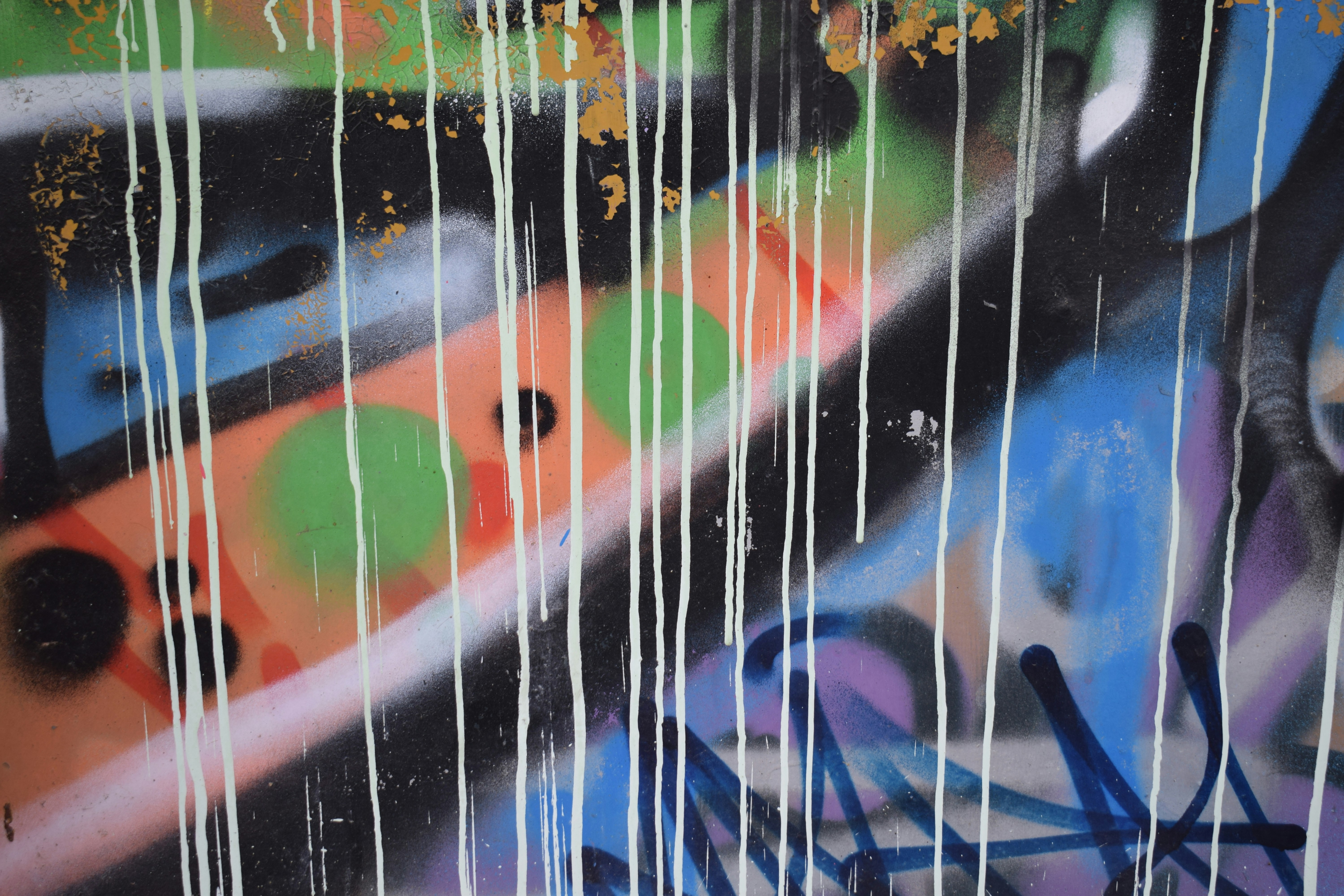 Graffiti art with dripping paint and colorful shapes