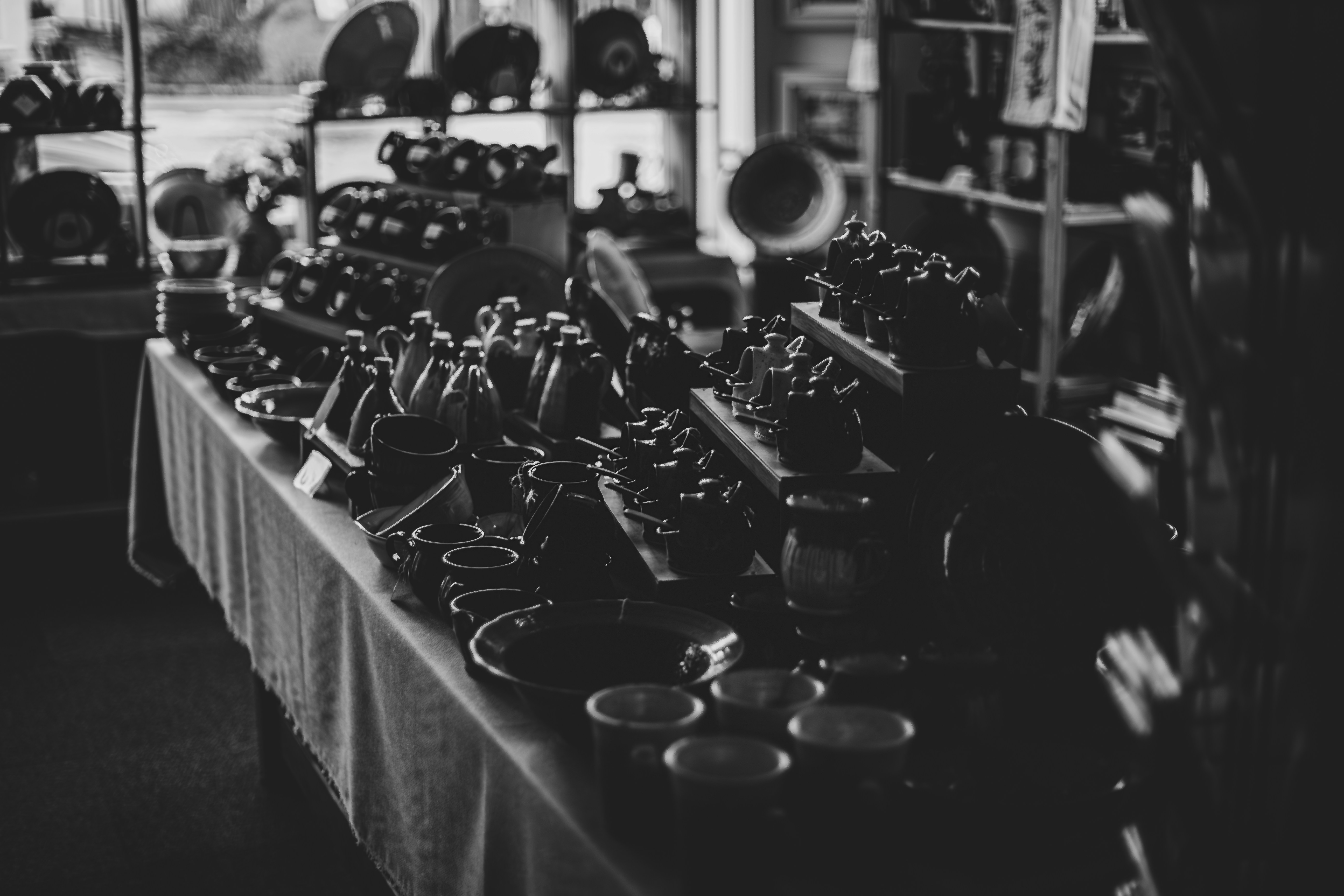 Collection of ceramic teapots and cups on display