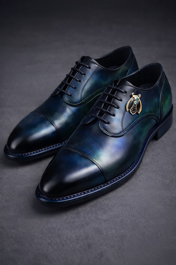 Blue leather dress shoes with bee embellishment