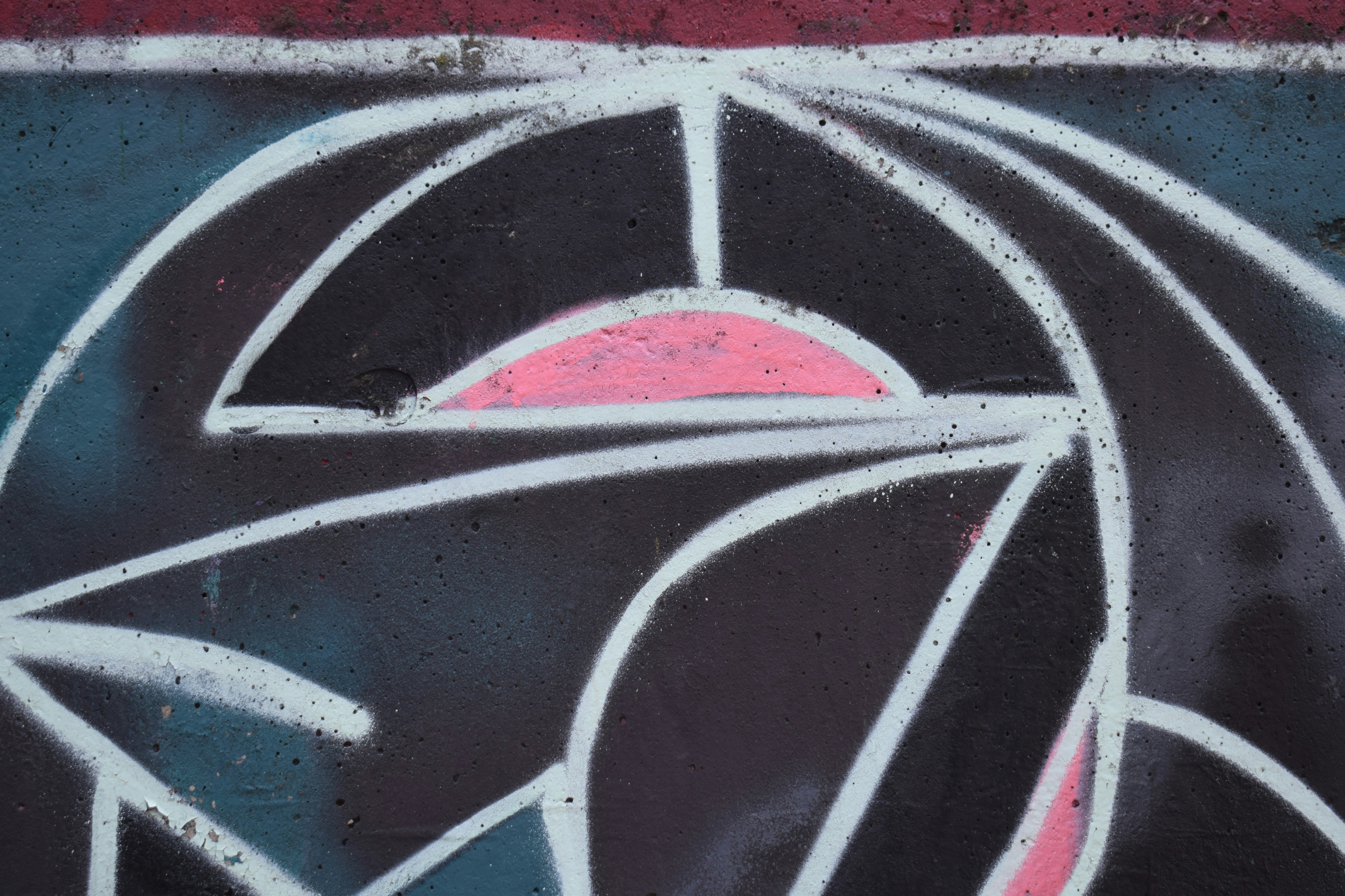 Abstract geometric design with pink and white lines.