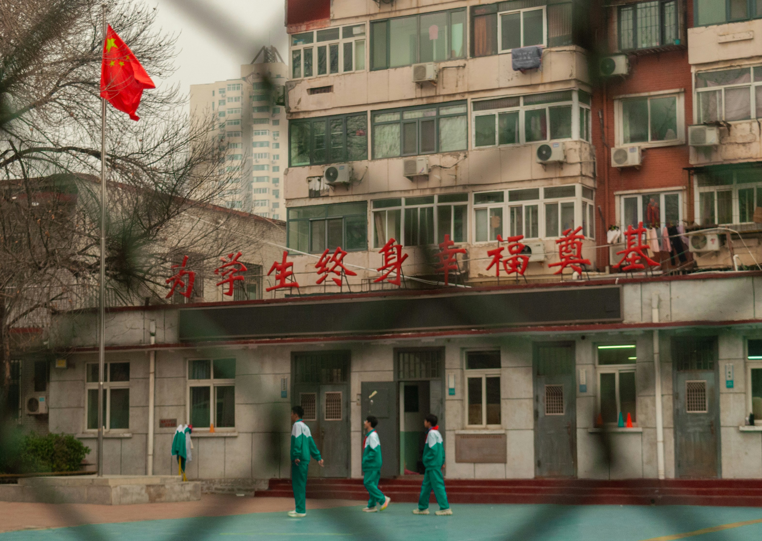 School building with chinese flag and students