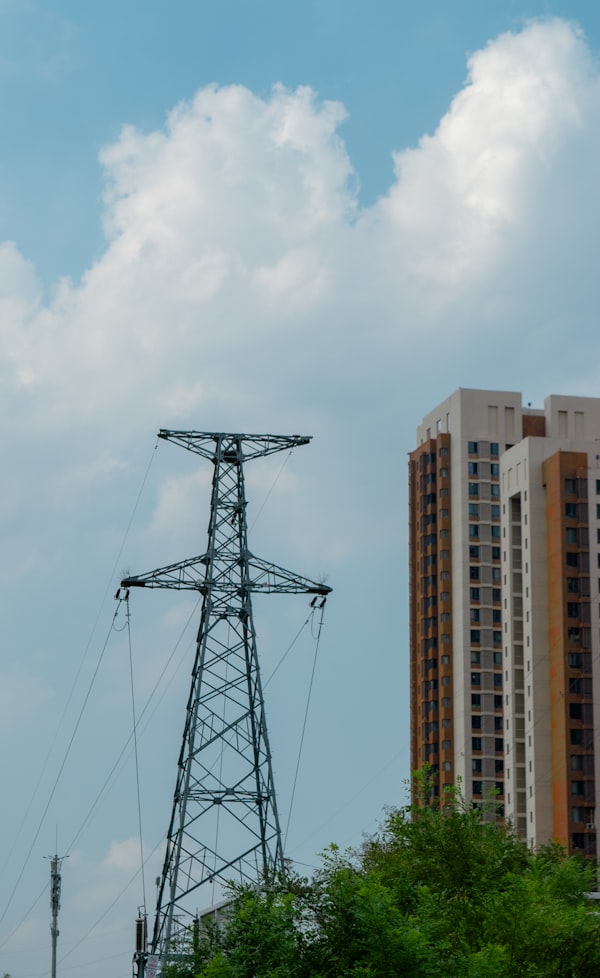 Power tower beside modern apartment buildings