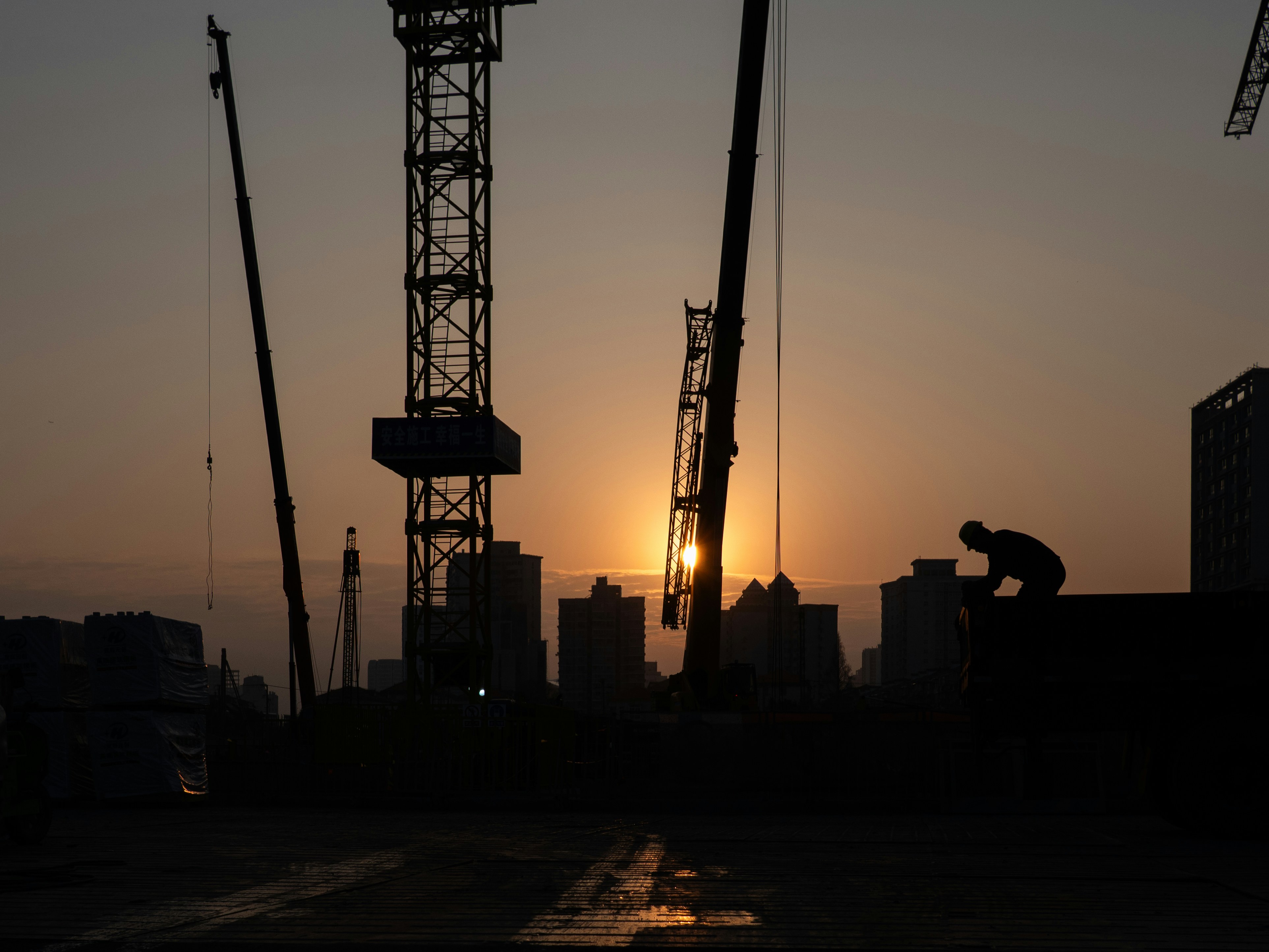 Silhouette of construction site at sunset with sunset.