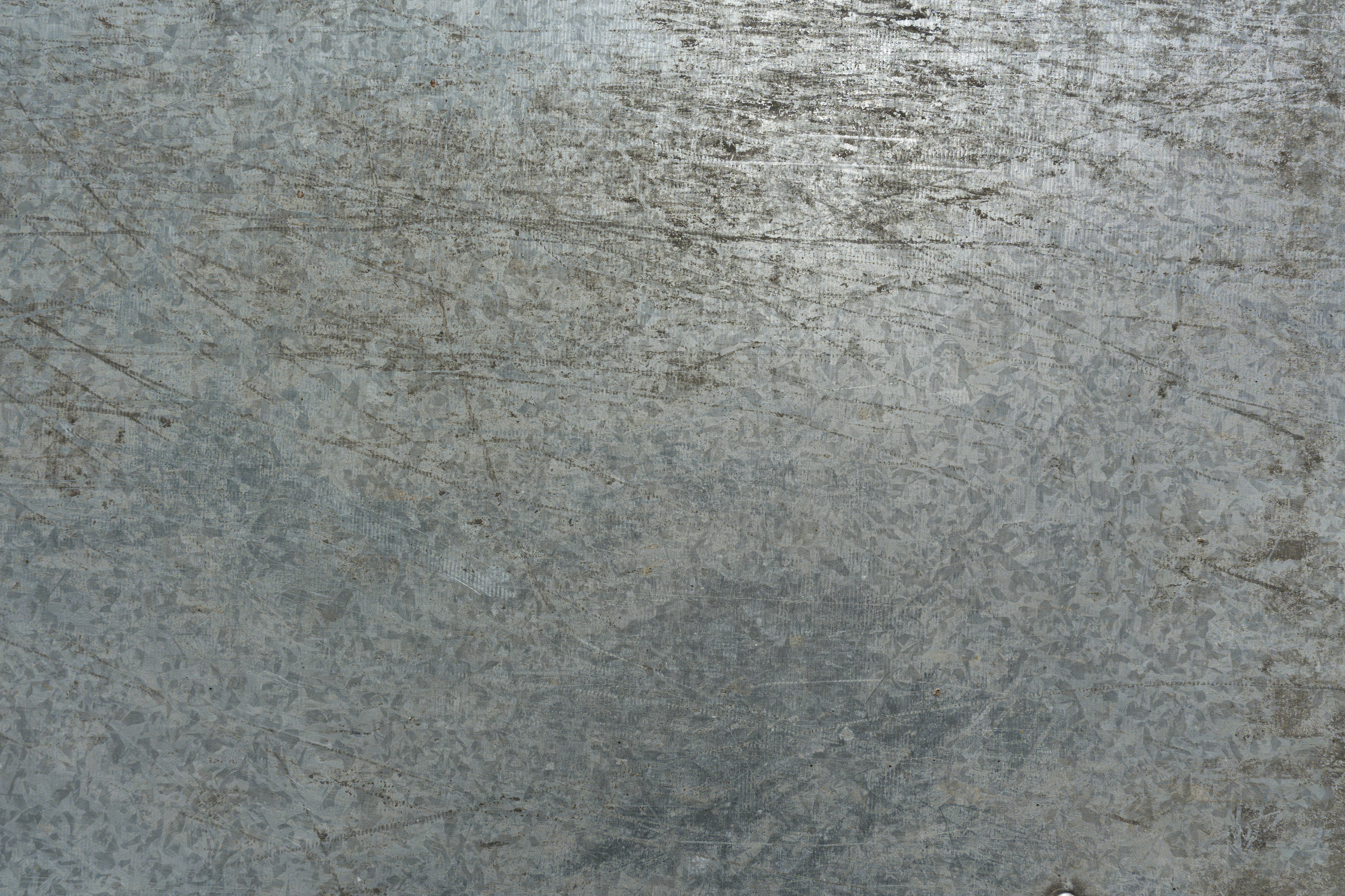 A textured metallic surface with scratches