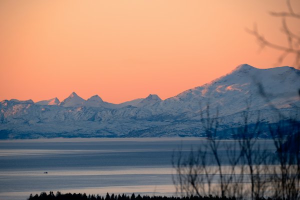 Snow-capped mountains at sunset across the fjord — Narvik, Norway