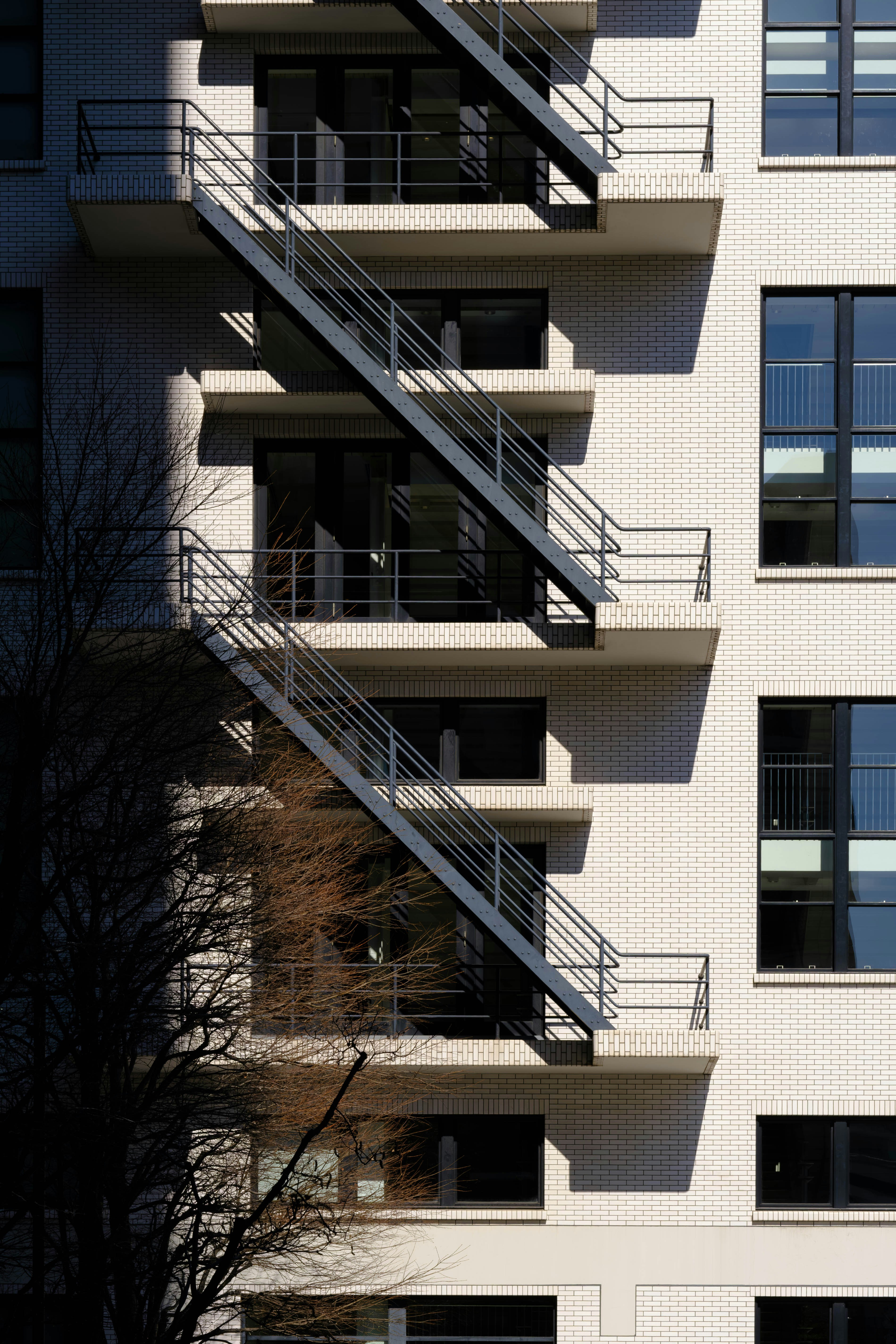 Modern building with external metal staircase and windows