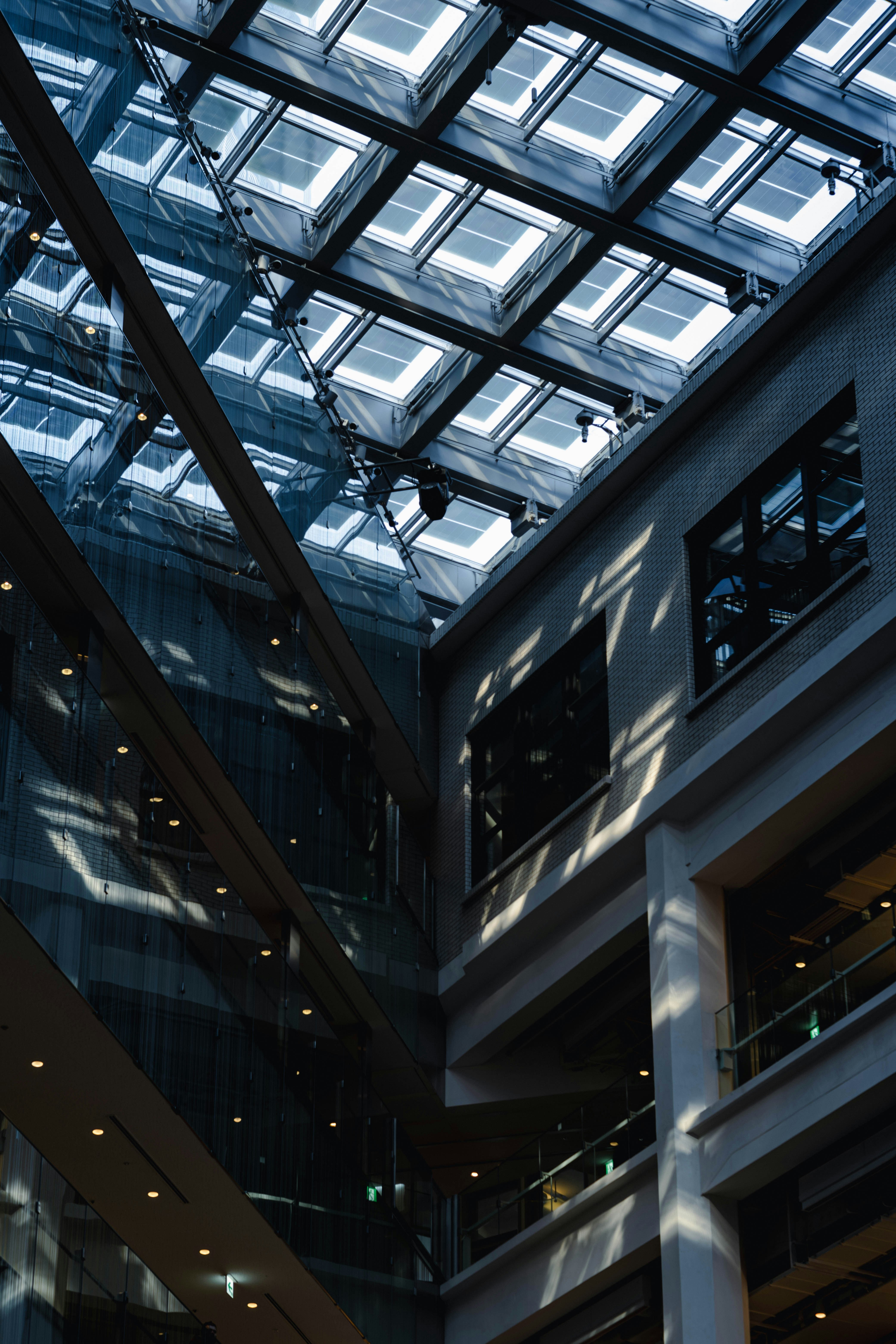 Modern building interior with glass ceiling and shadows