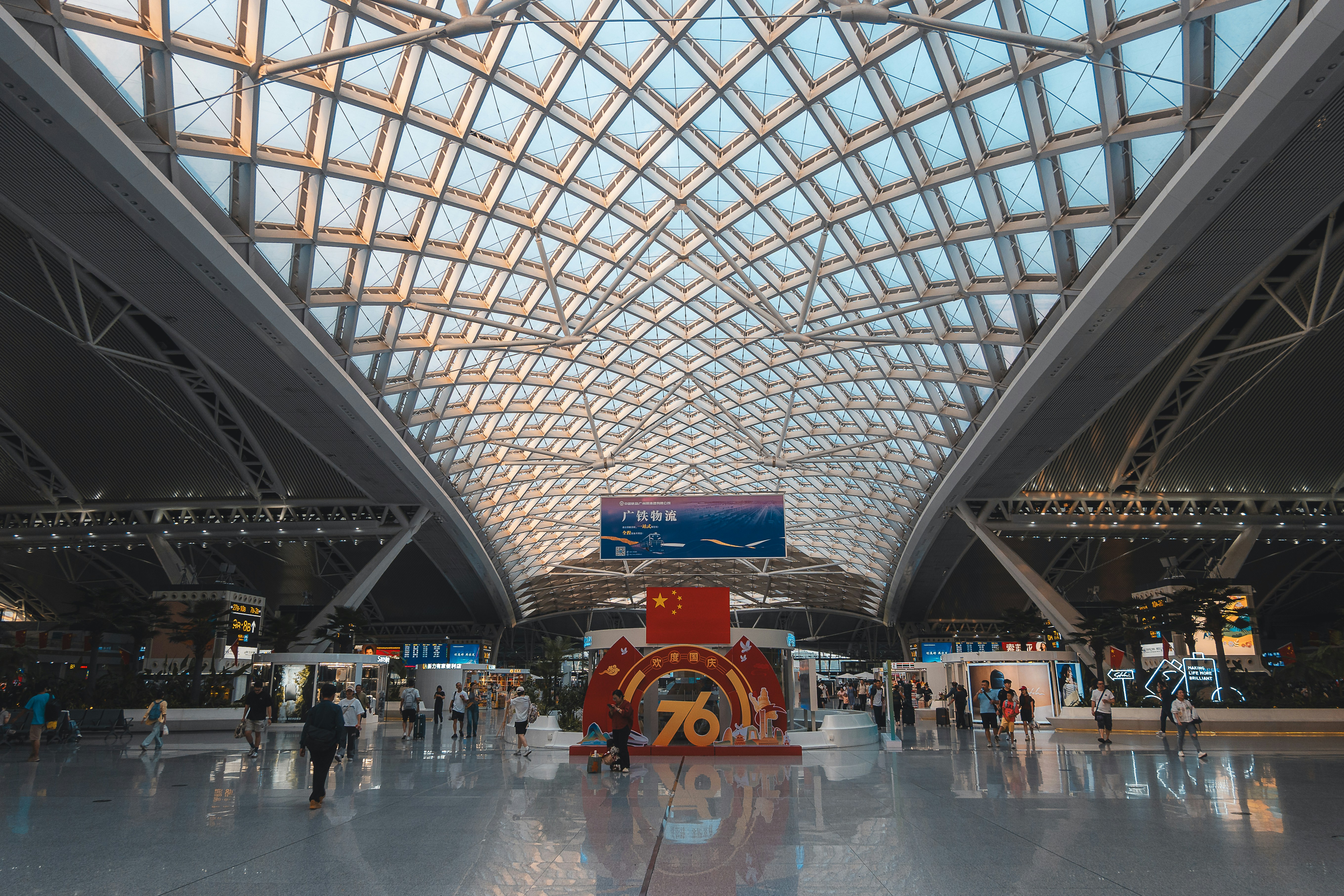 Modern interior of a large convention center with geometric ceiling.