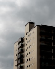 Tall apartment building against a cloudy sky