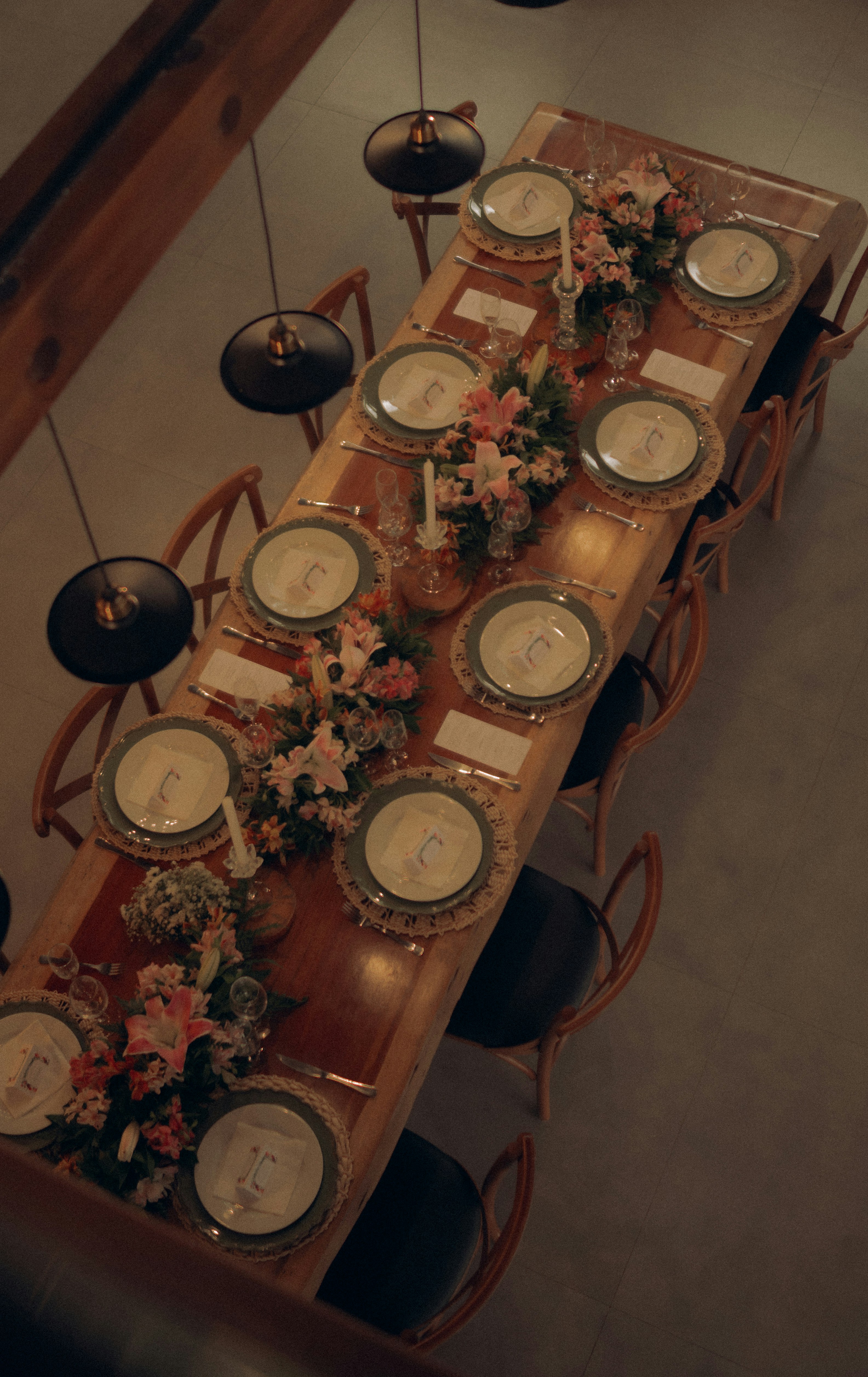 A beautifully set dining table with floral arrangements.
