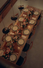 A beautifully set dining table with floral arrangements.