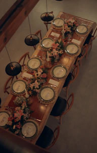 A beautifully set dining table with floral arrangements.