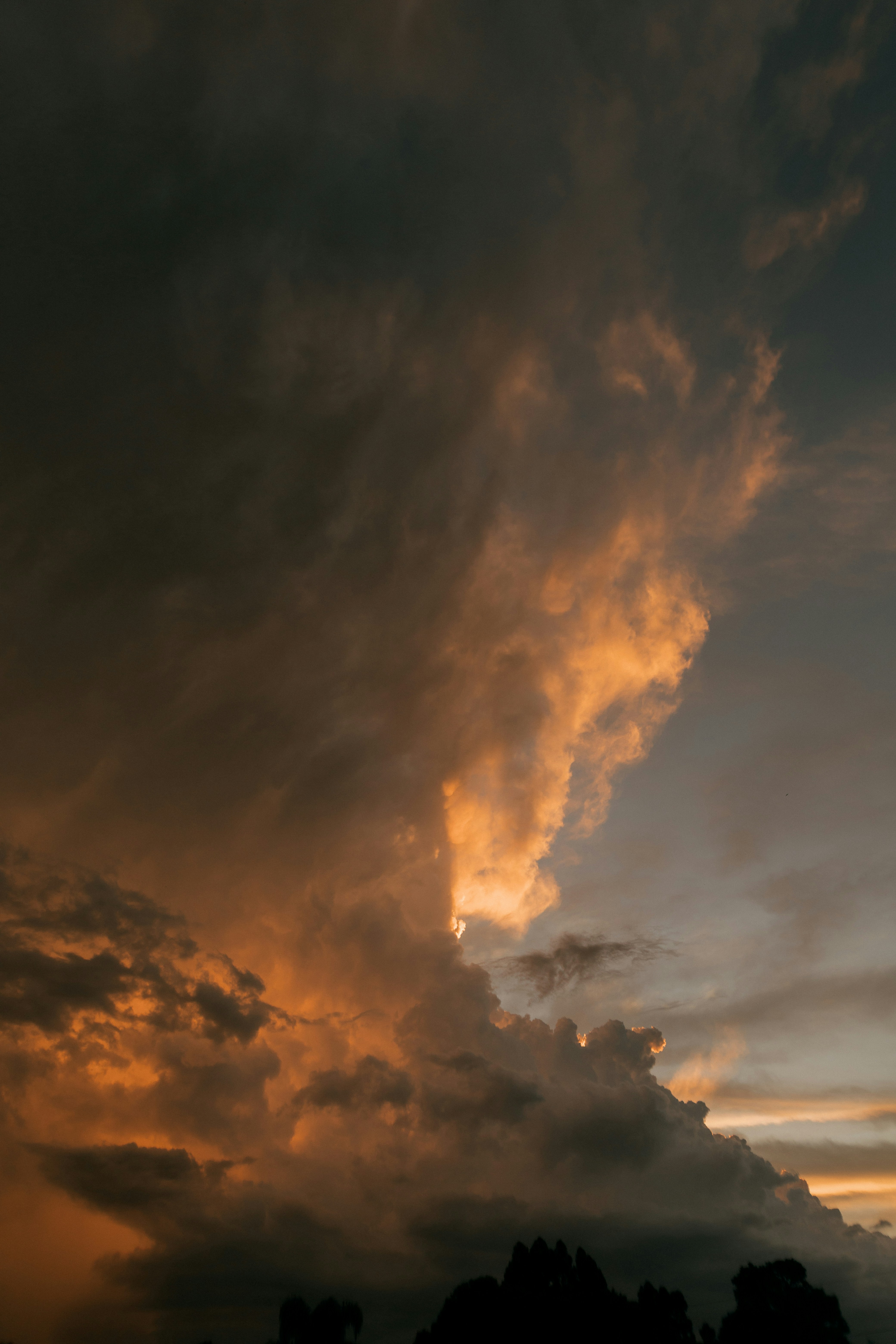 Dramatic sunset clouds illuminated by golden light.