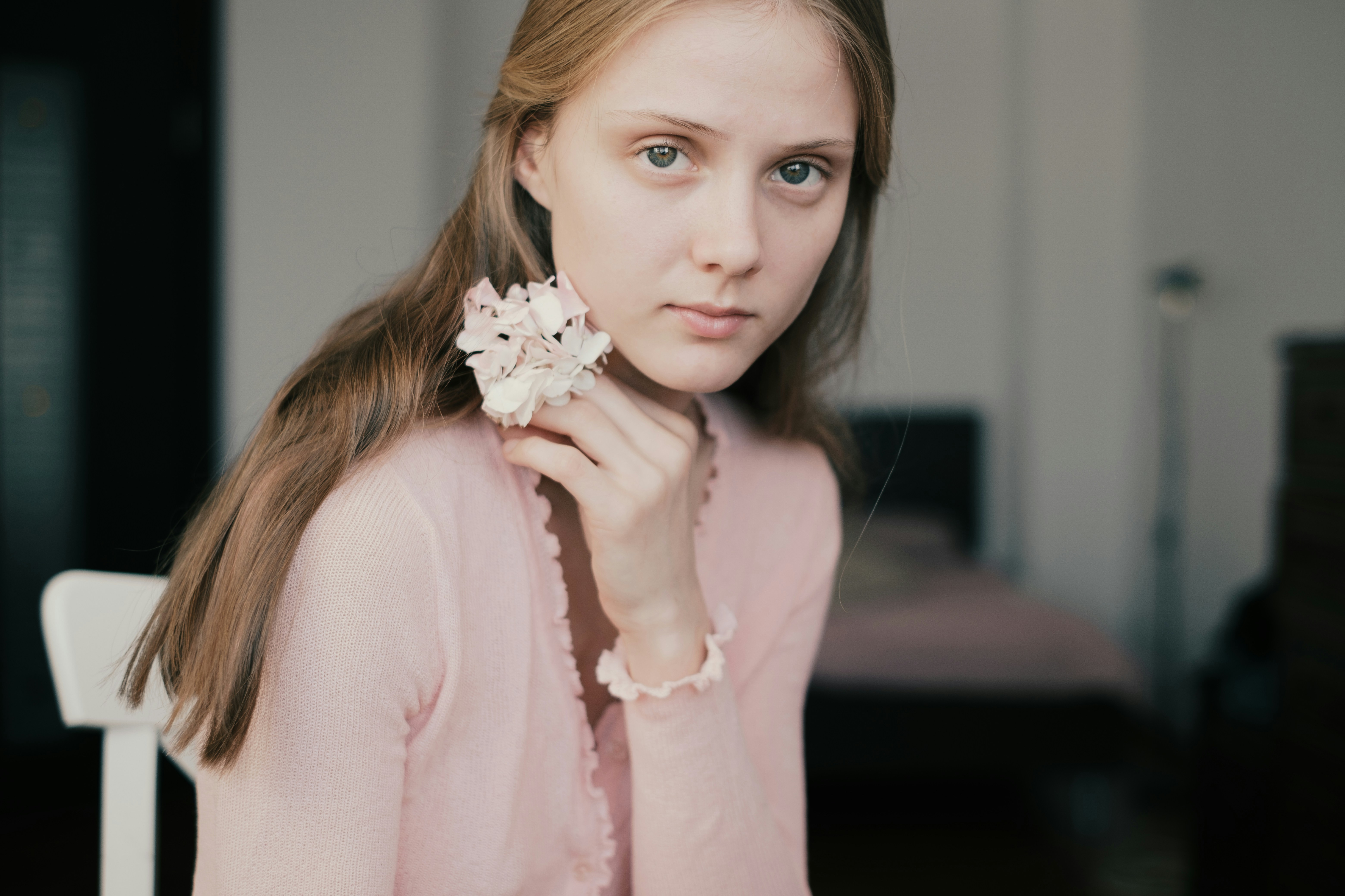 Young woman holding a delicate flower