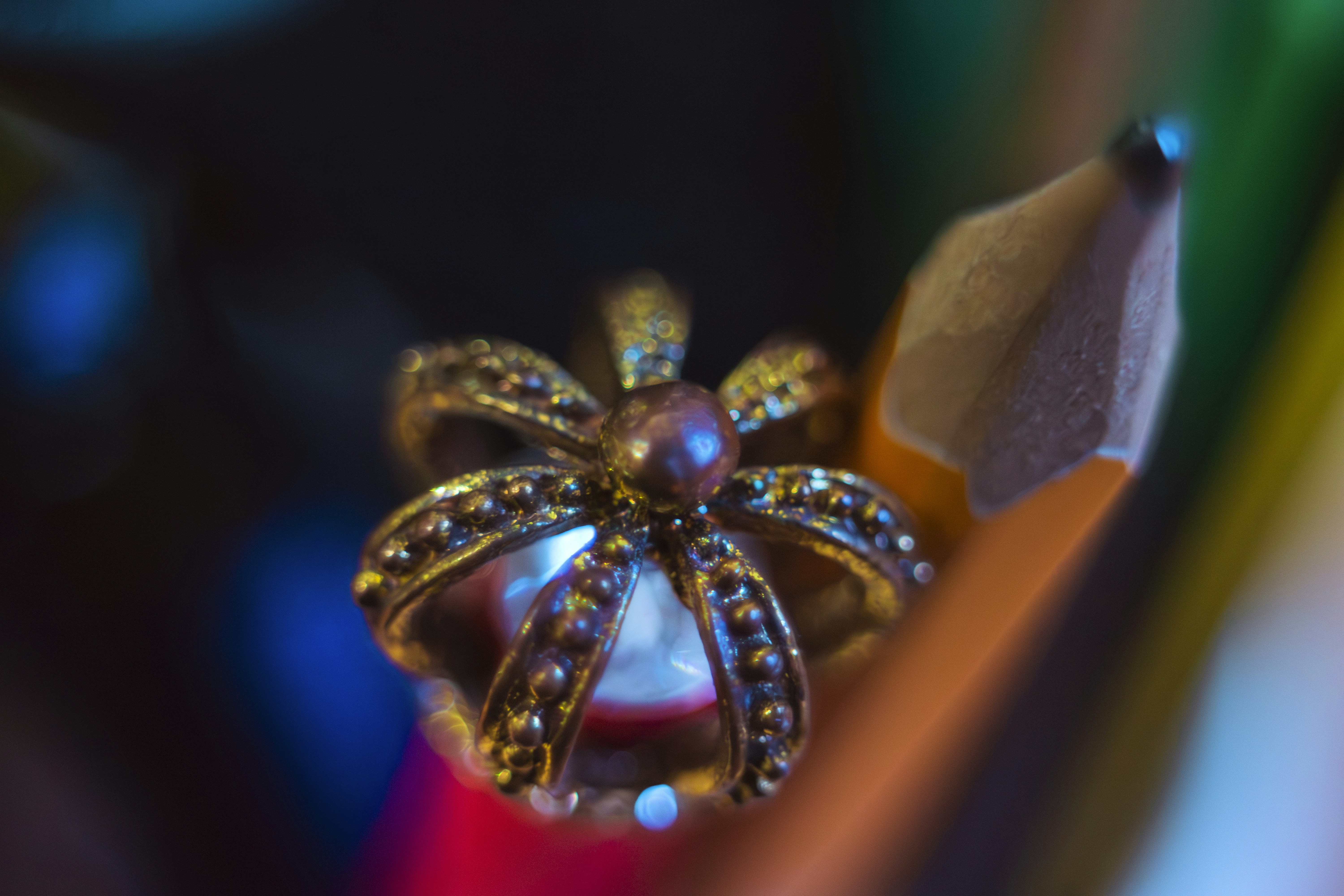 A decorative crown sits atop a sharpened pencil tip.