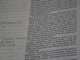 Close-up of an open bible with handwritten notes.