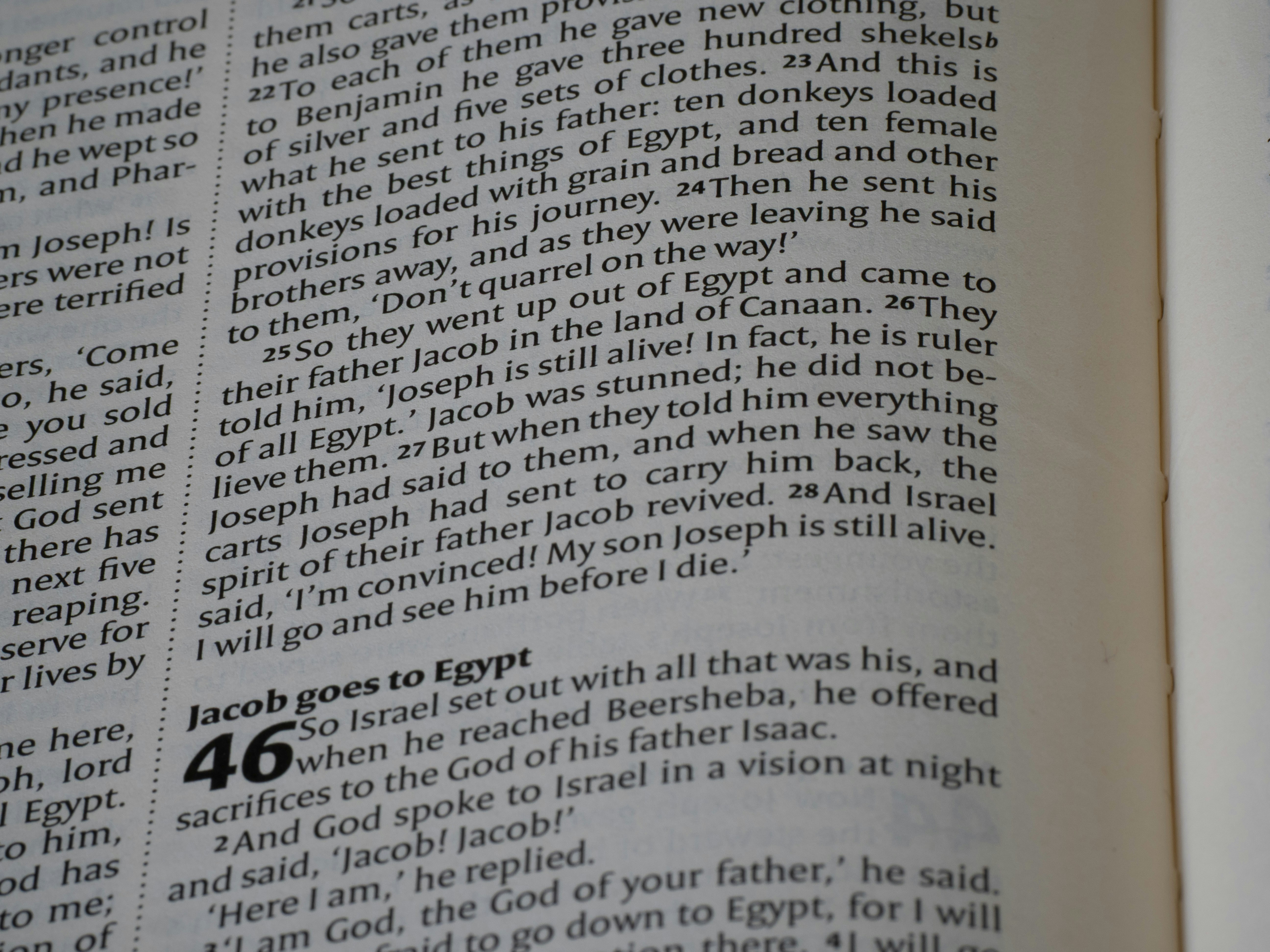 Close-up of an open bible with text visible.