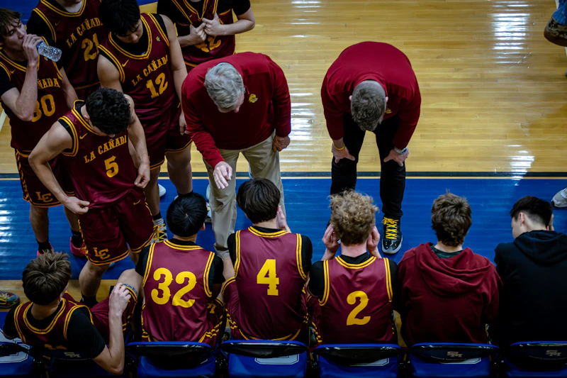 Basketball team listening to coaches during a timeout