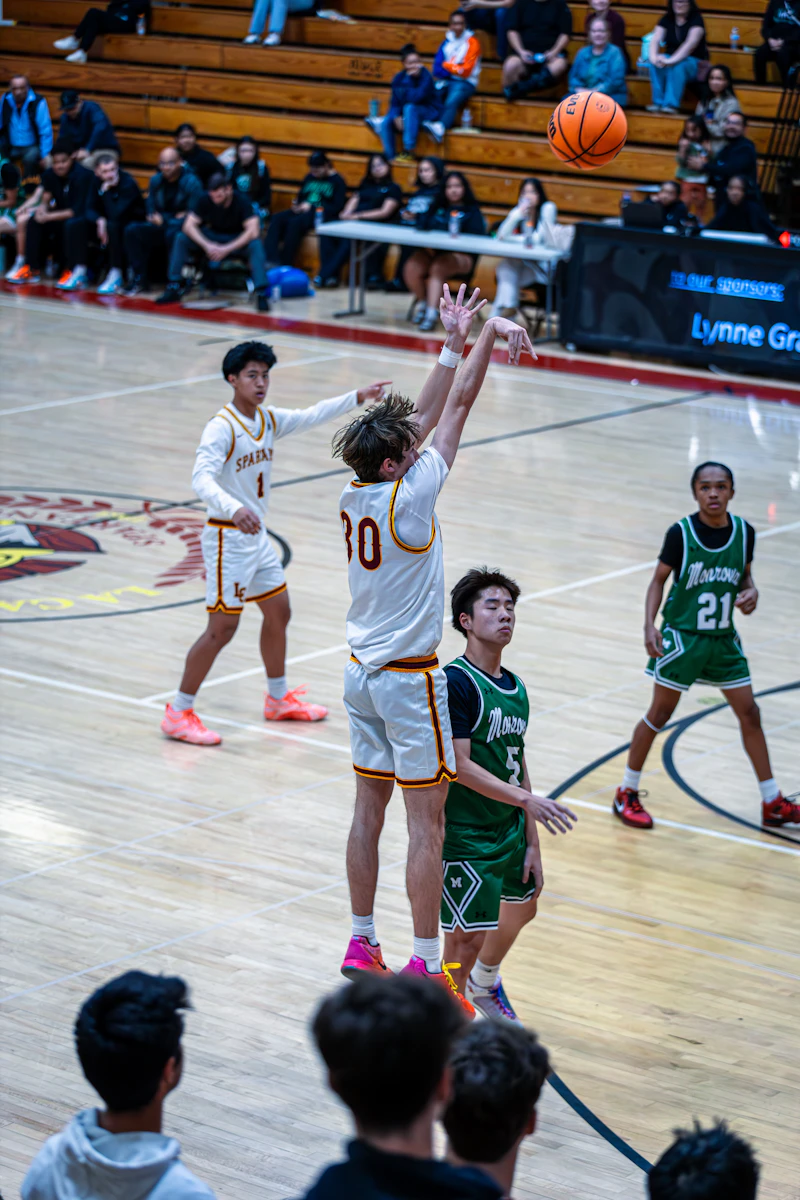 Teenager shooting a basketball during a game