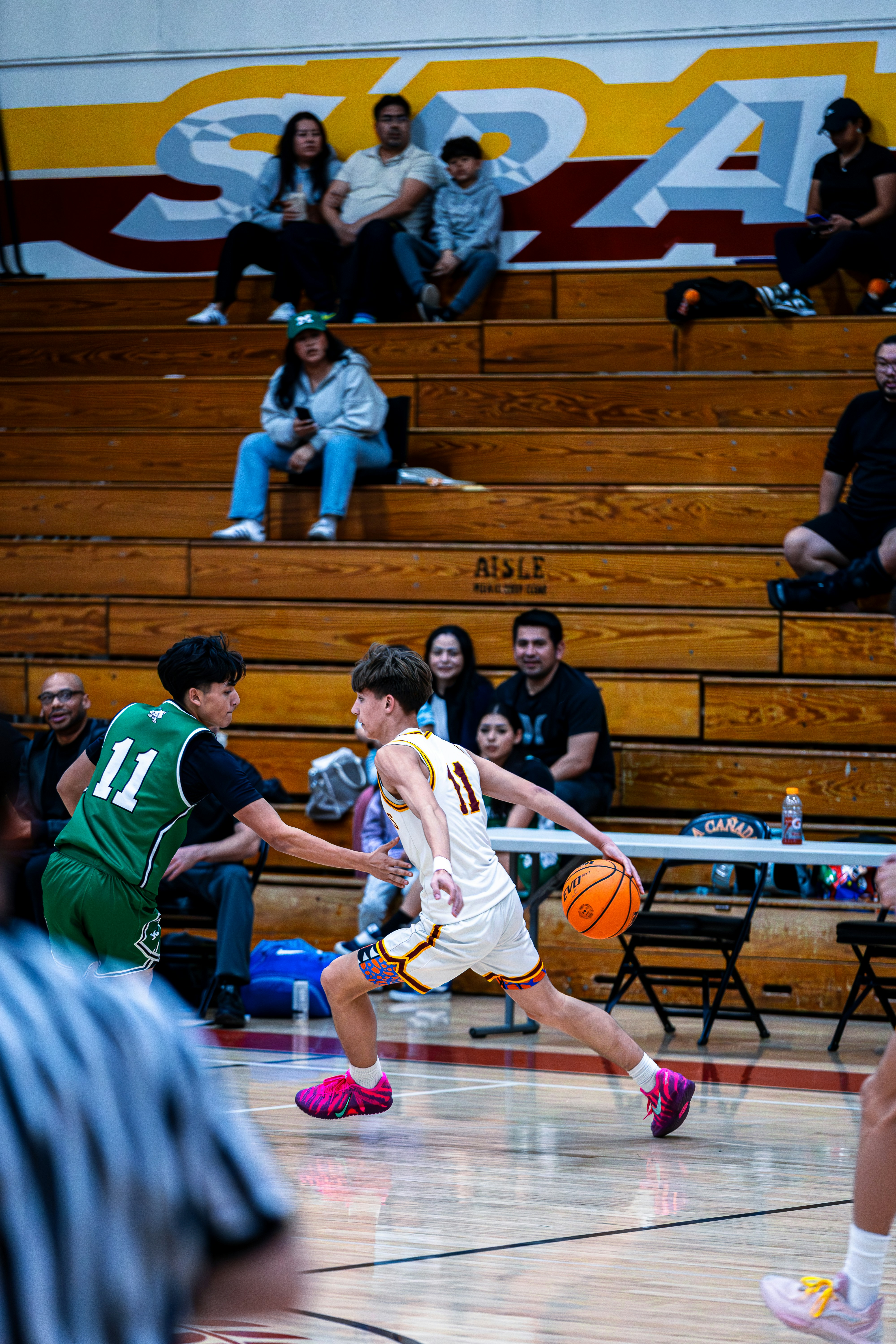 Basketball players competing on a court during a game.