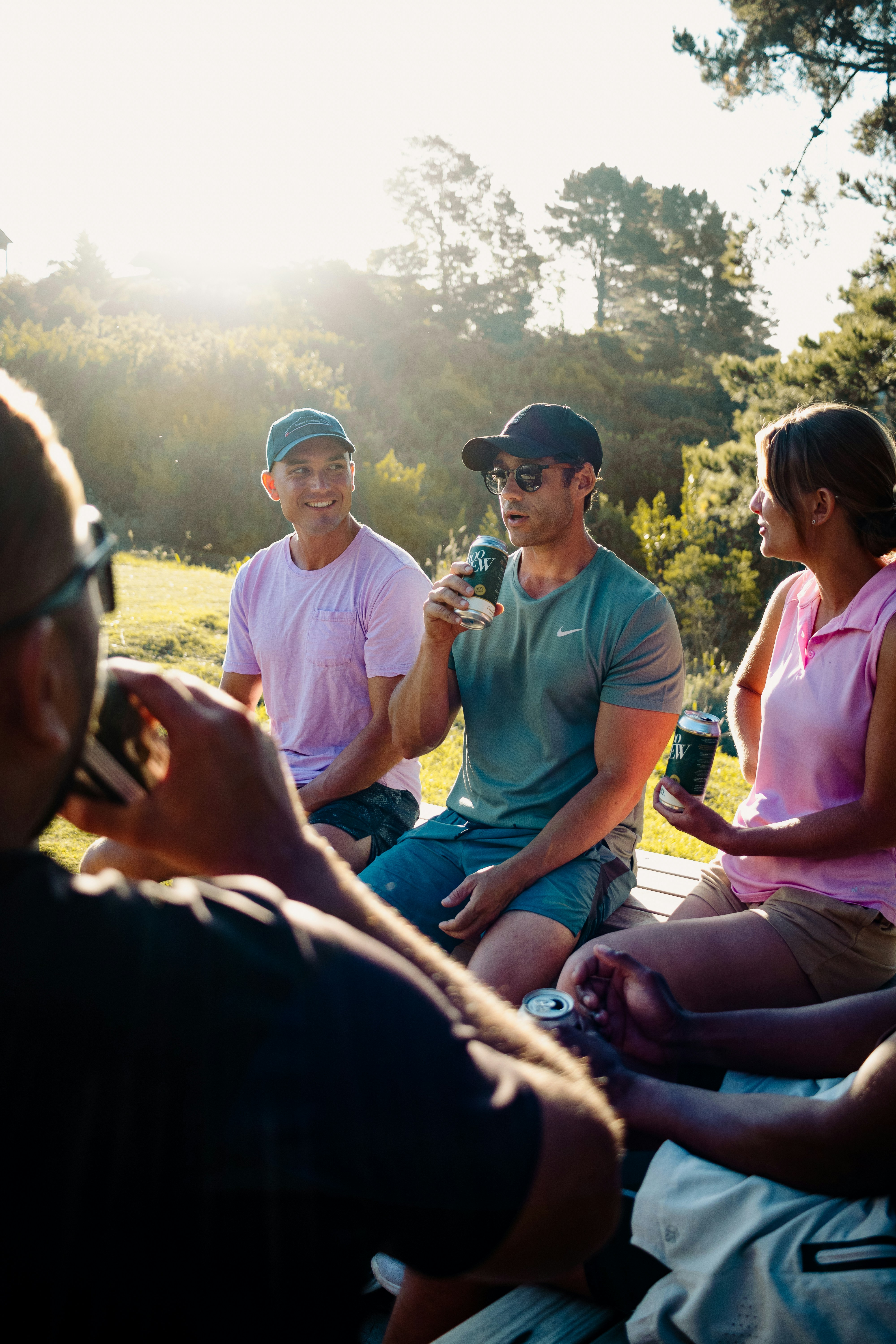Friends enjoying drinks outdoors in the sunlight
