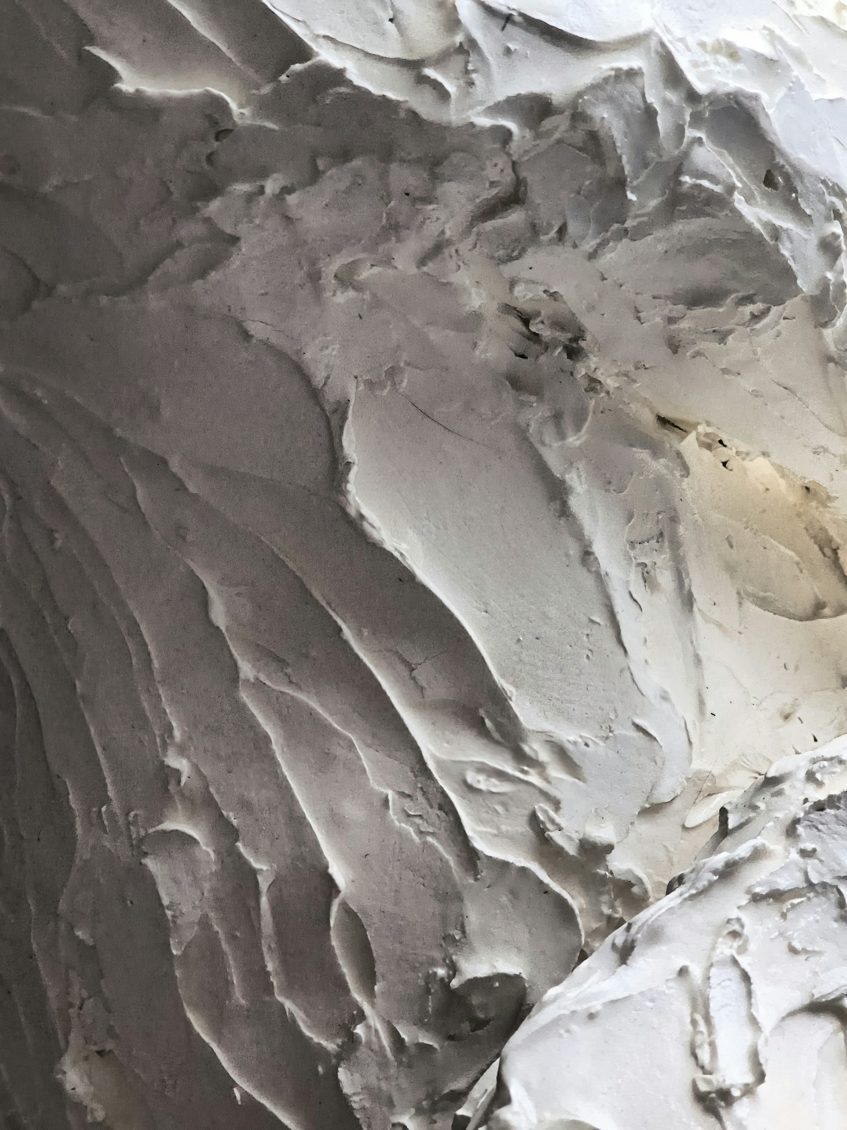 Textured white surface with dramatic light and shadow