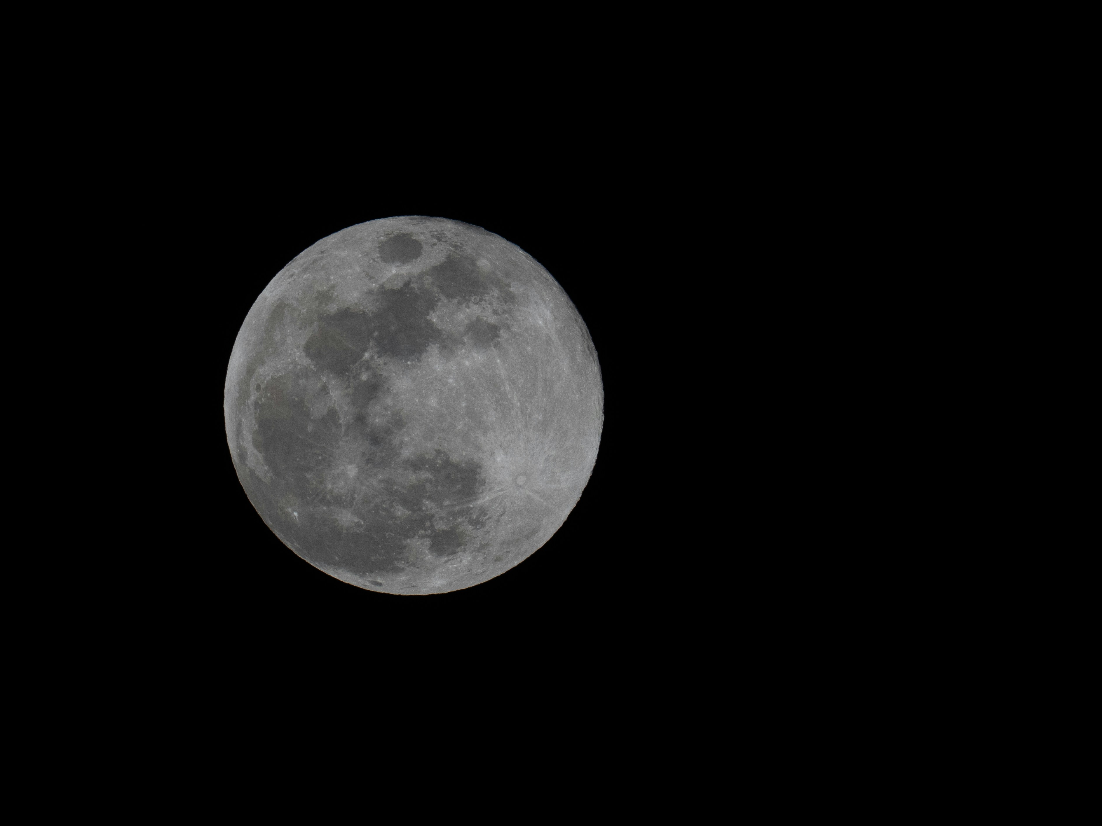 Full moon glowing in the dark night sky