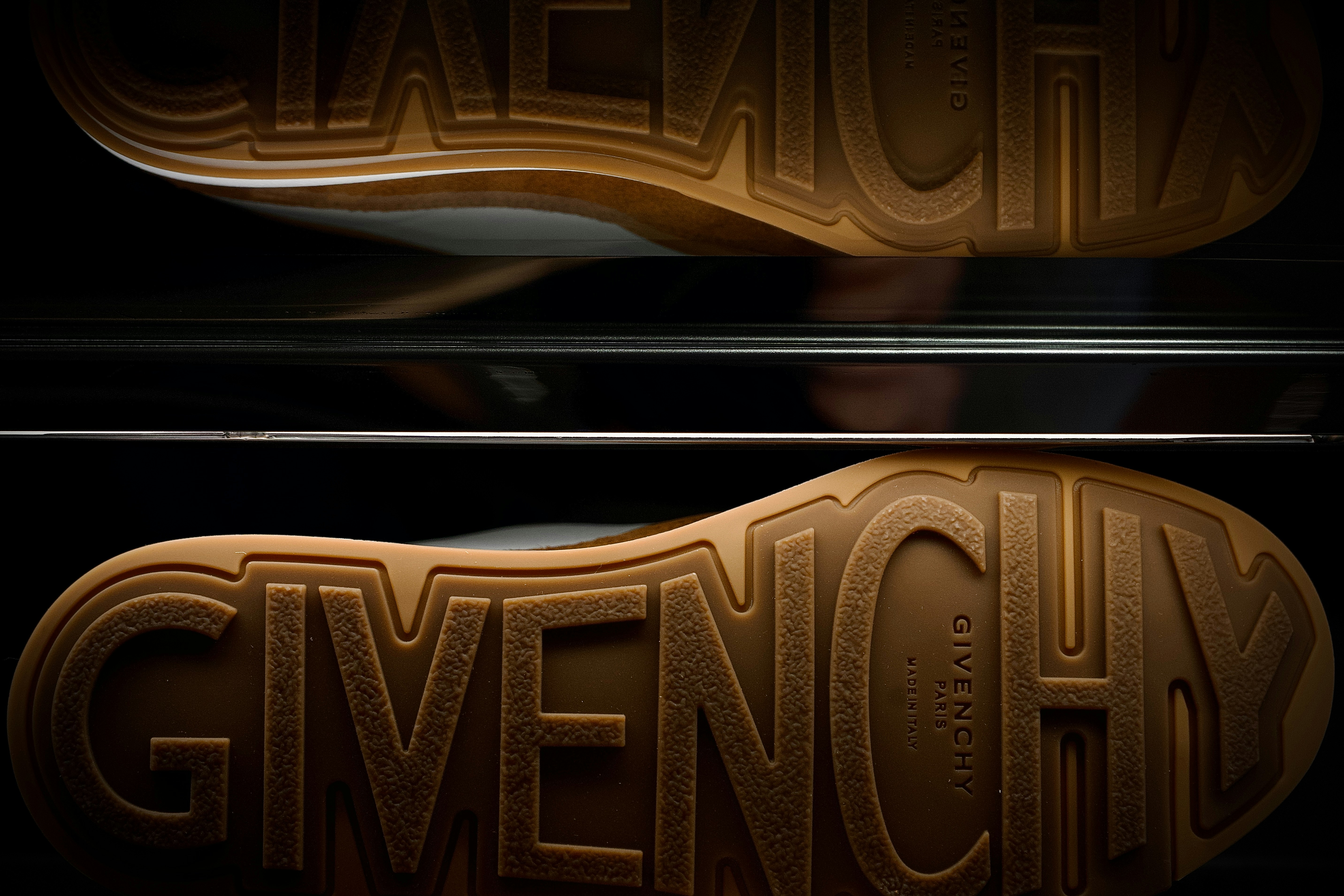 Close-up of givenchy shoe soles stacked