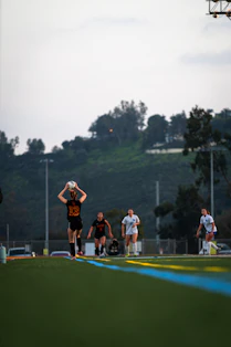 Soccer players on a field preparing for a throw-game